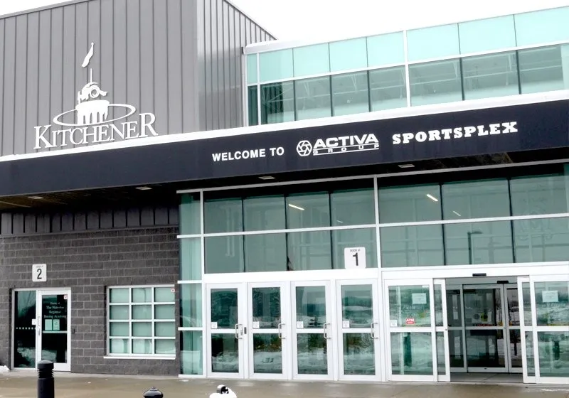 The glazed front entrance of the Activa Sportsplex with the Kitchener crest and Welcome to Activa Sportsplex lettered above the doors. — Activa Sportsplex