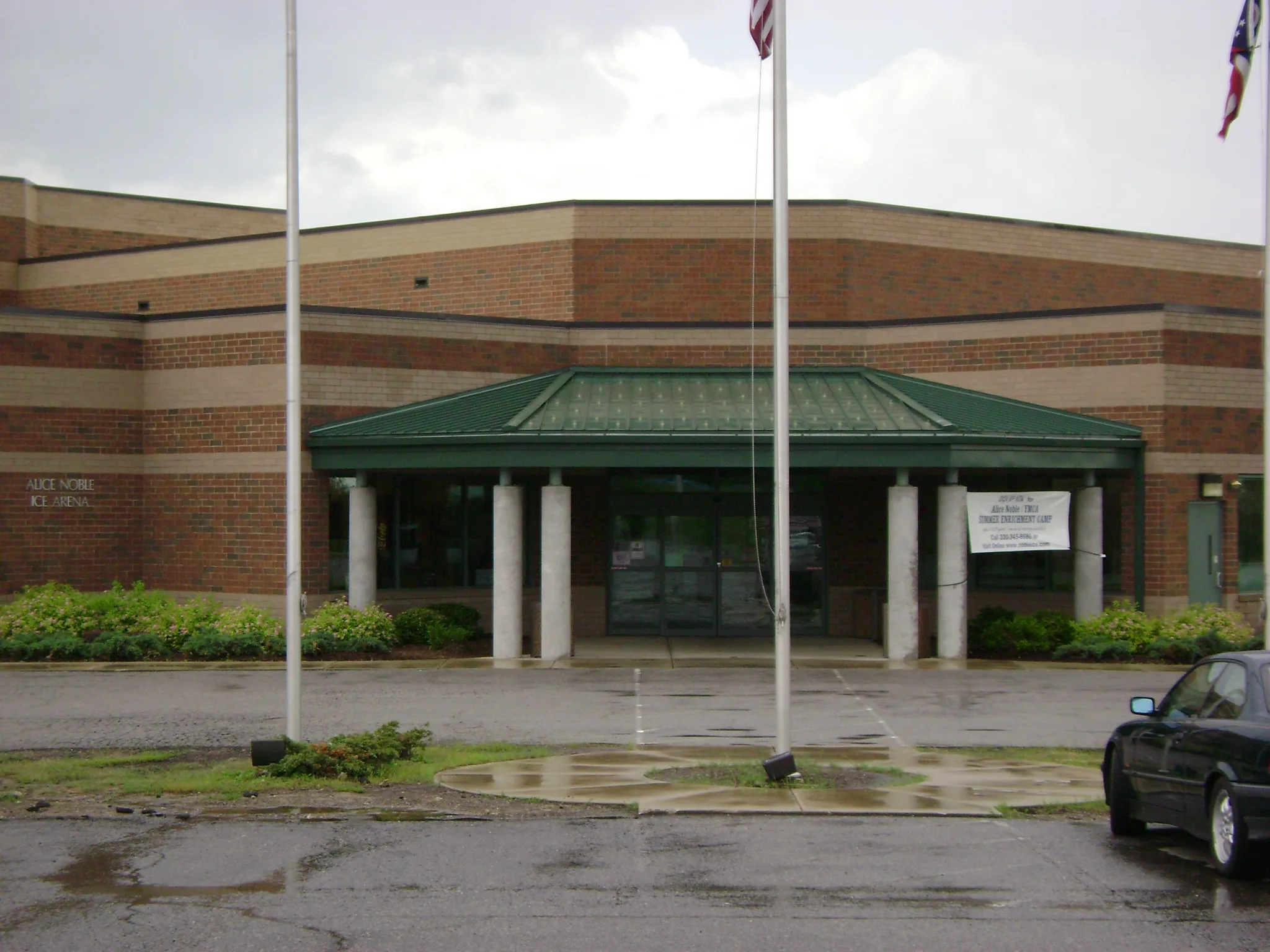 Low banded red-brick and buff-brick arena — Alice Noble Ice Arena (Wooster)