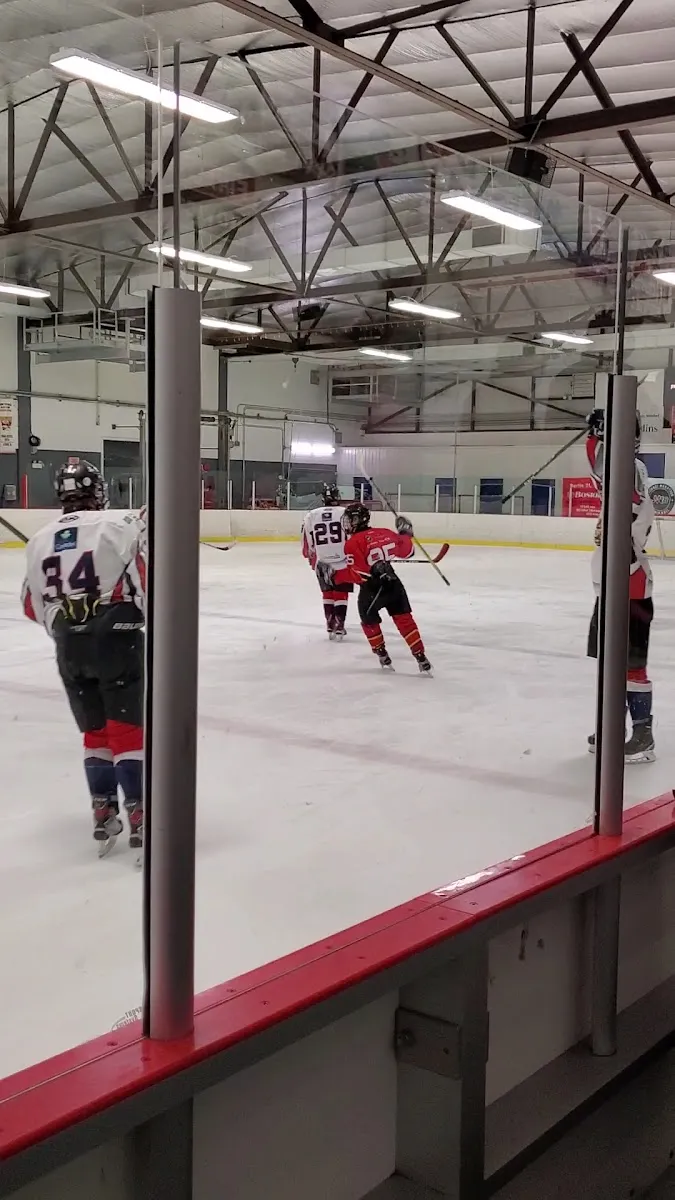 A hockey game on the arena ice seen through the glass at the Aréna Jean-Laurin in Mirabel — Aréna Jean-Laurin (Mirabel)