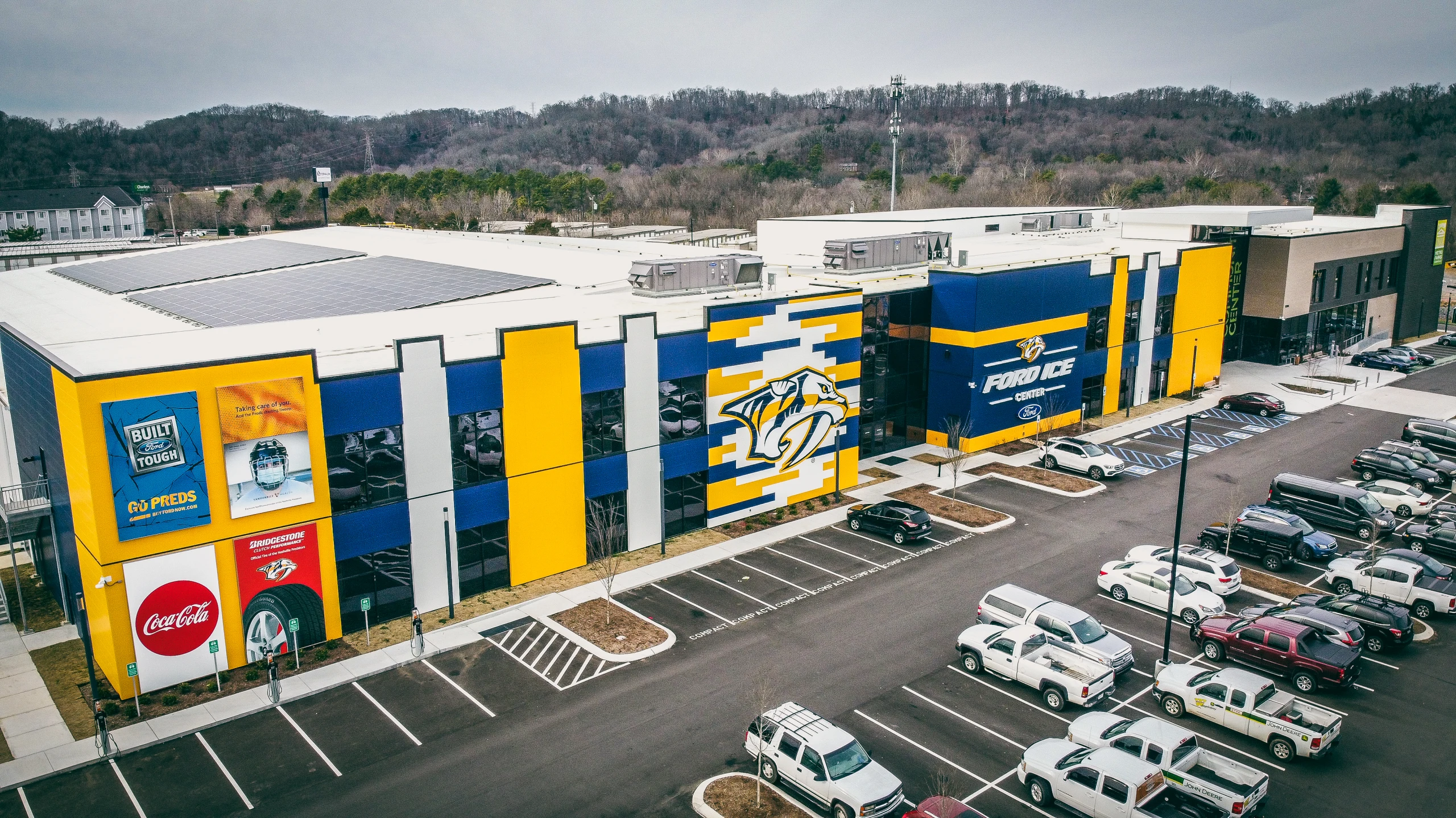 Drone shot over the parking lot and solar roof — Ford Ice Center – Bellevue