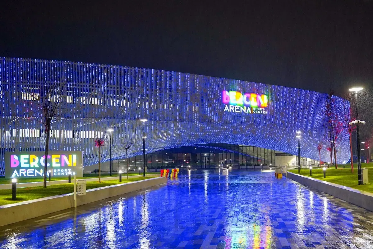 The illuminated glass facade of Berceni Arena at night — Berceni Arena (Doru Tureanu)