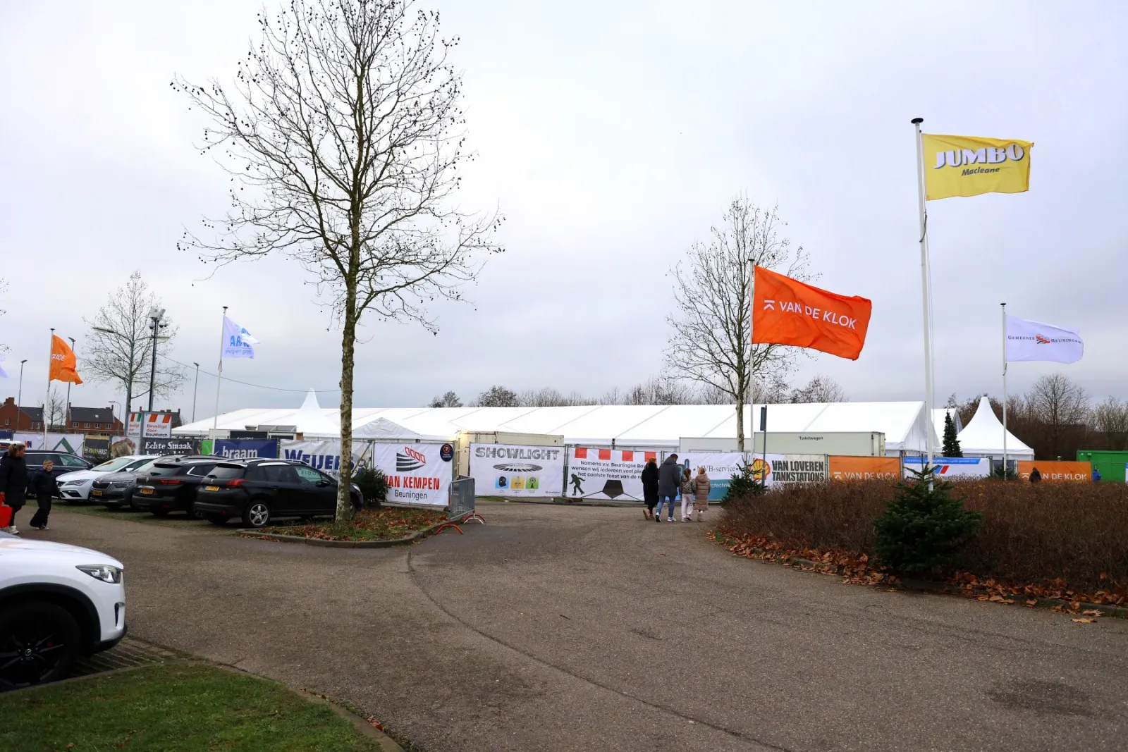 The entrance of Beuningen on Ice: the big white tent behind the car park, with the sponsor flags and banners – Beuningen On Ice (Beuningen Gld)