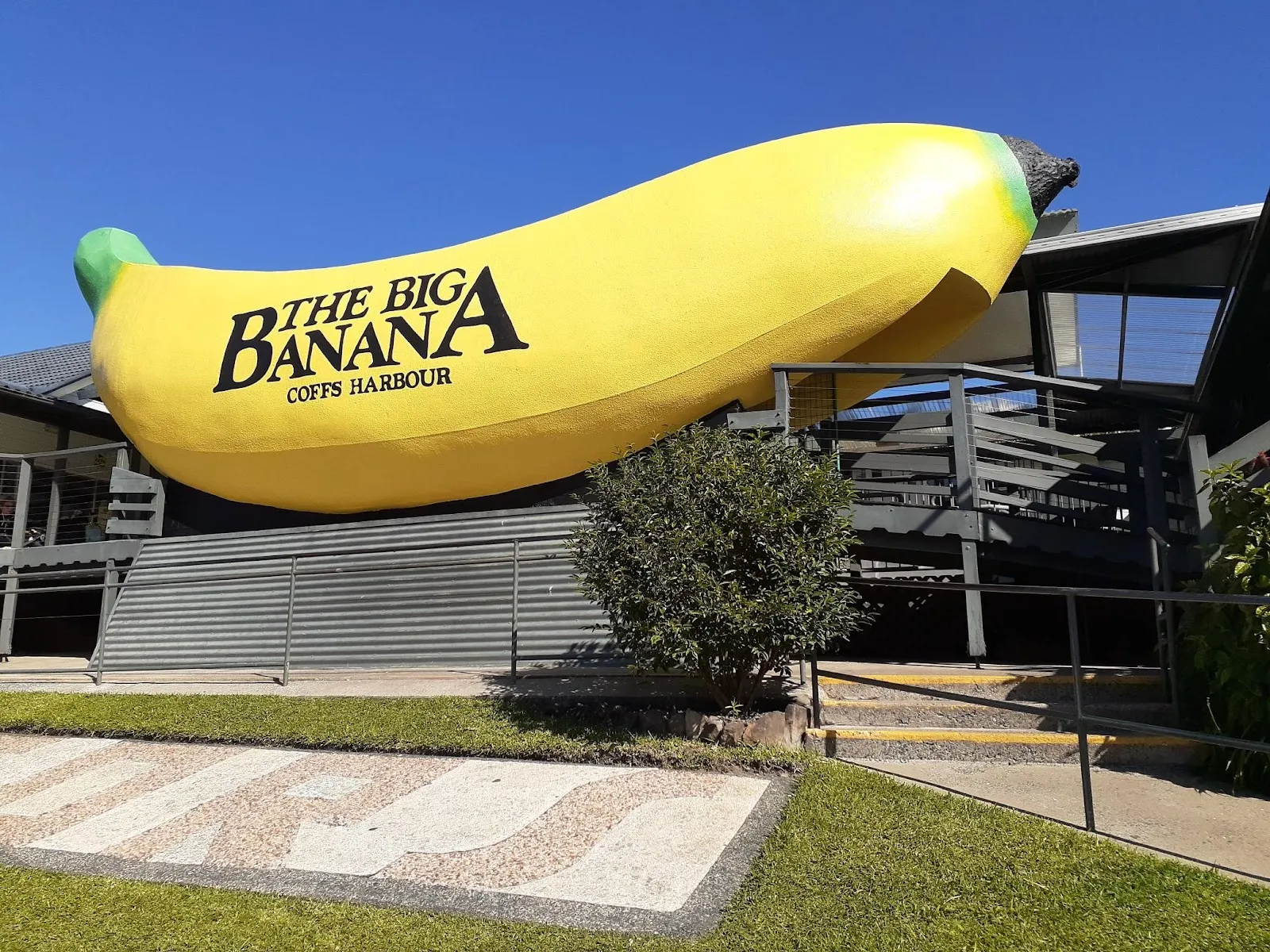 The giant yellow banana landmark at the Big Banana Fun Park in Coffs Harbour, the park that houses the ice rink, with lawn in front. — Big Banana Fun Park Ice Rink
