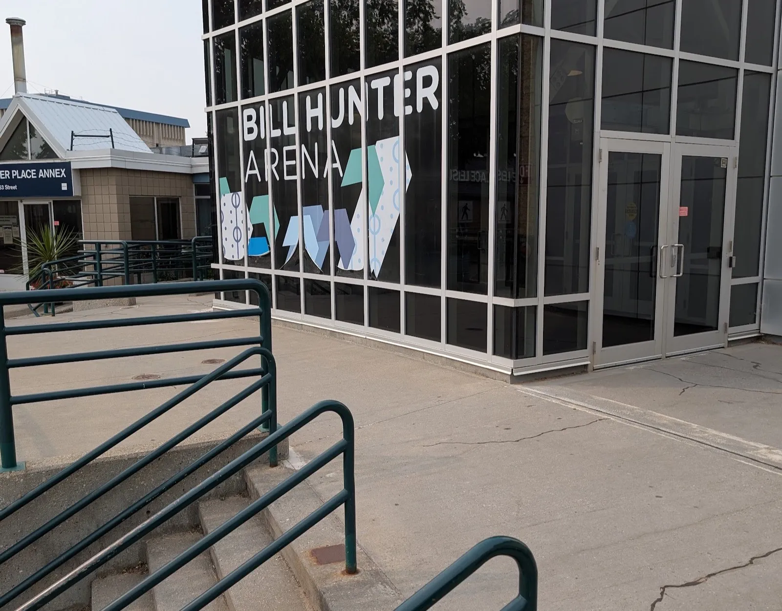 The glass entrance block of the Bill Hunter Arena on 163 Street in Edmonton, with the arena's name lettered across its windows — Bill Hunter Arena