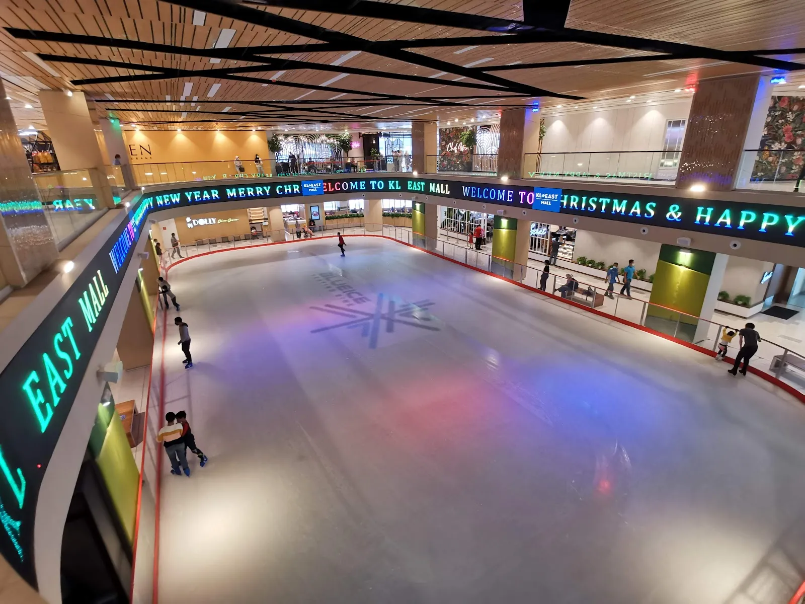 The 30 by 15 metre sheet at Blue Ice in KL East Mall, with the mall's LED sign running along the rink wall. — Blue Ice Skating Rink KL East Mall