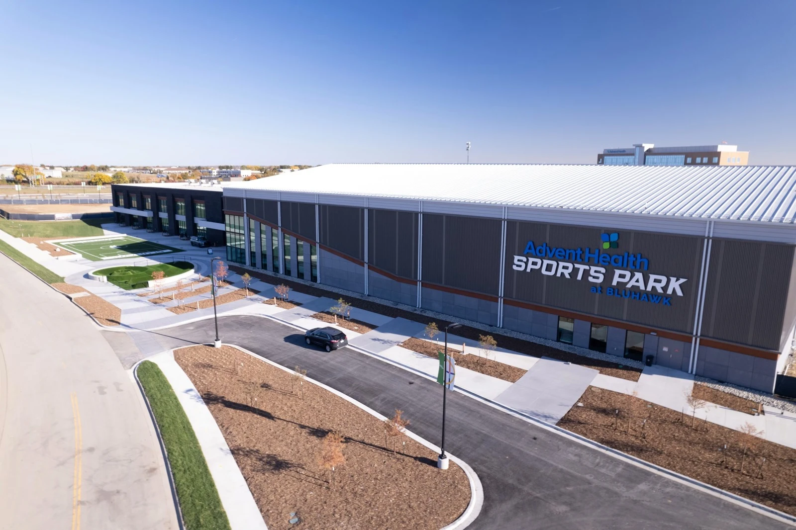 An elevated view of AdventHealth Sports Park at Bluhawk’s exterior and entrance approach. — AdventHealth Sports Park at Bluhawk
