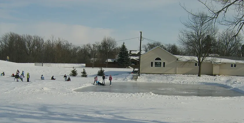 Skaters on the community skating rink area beside the Family Community Center in Breckenridge, Minnesota, in winter. — Breckenridge Skating Rink