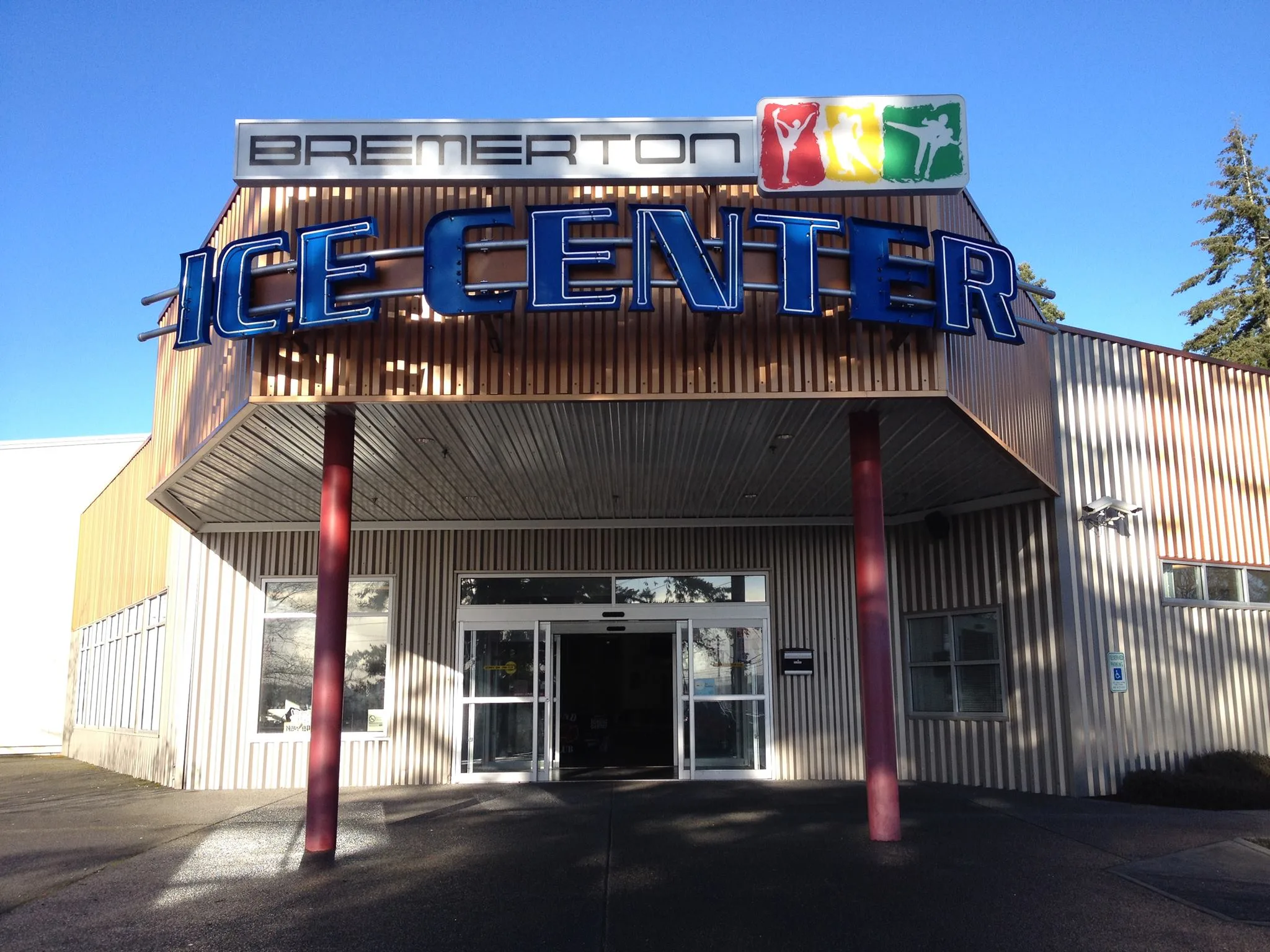 Same entrance from a low three-quarter angle in low golden light — Bremerton Ice Center