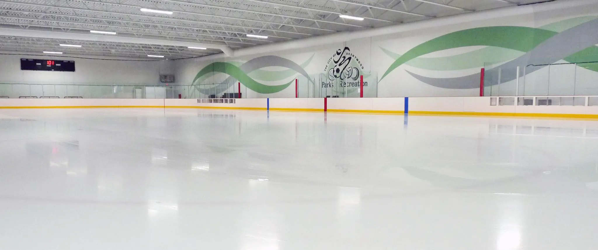 A parks department mural above the far boards — Brentwood Ice Rink