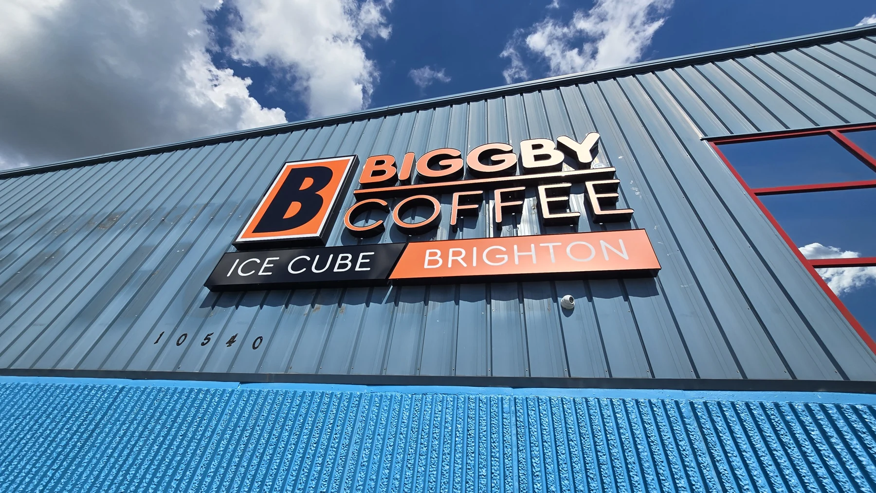 The blue exterior and BIGGBY Coffee Ice Cube Brighton sign above the entrance area. — BIGGBY COFFEE Ice Cube - Brighton