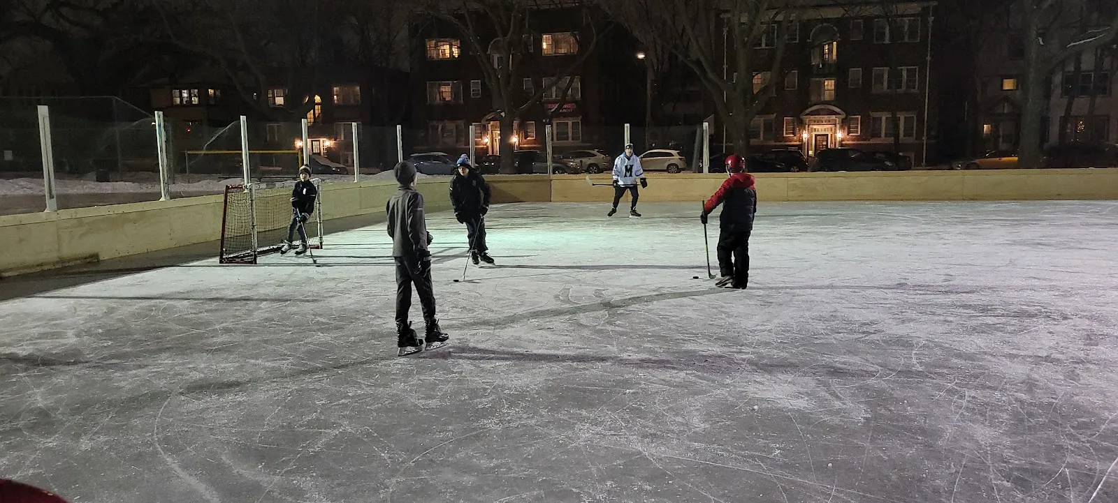 Skaters and hockey players at night on the Bryant Square Park outdoor rink, Minneapolis (Google Maps listing photo) — Bryant Square Park Outdoor Rink