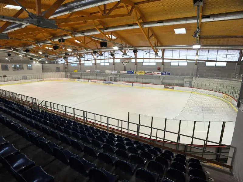 The empty ice and blue stands of the Buly Aréna ice hall in Kravaře — Buly Aréna