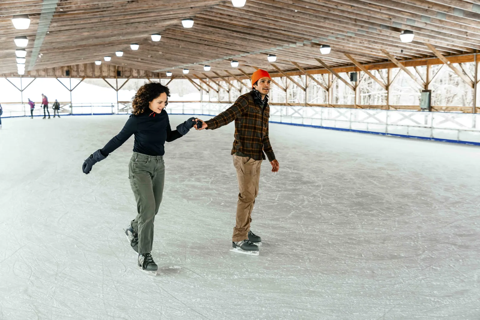 Two skaters on the covered outdoor rink behind the lodge, from the resort's ice skating page — Canaan Valley Resort State Park Ice Rink