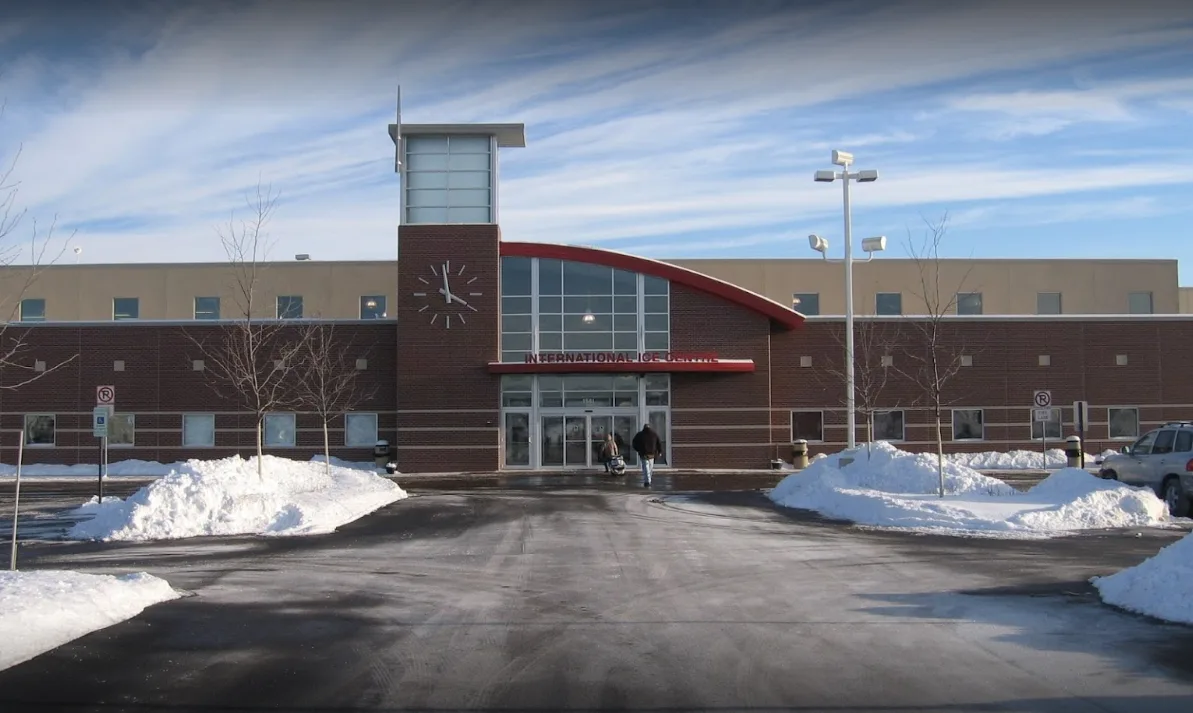 Red brick, clock tower and curved entrance canopy after a plough — Canlan Sports Romeoville