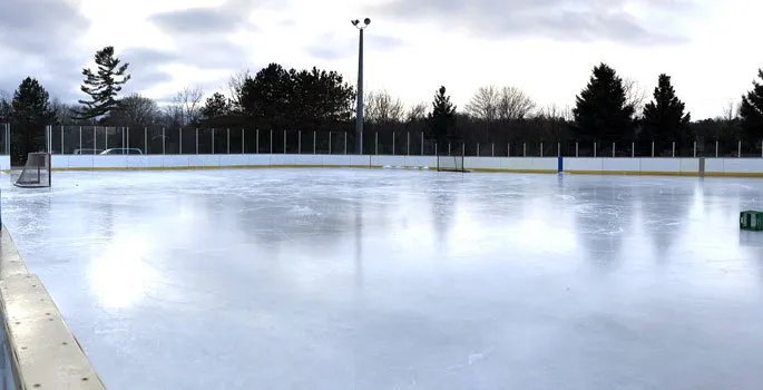 The outdoor ice at the Caroline Street rink in Port Hope, with the boards and fence around the ice surface. — Caroline Street Rink