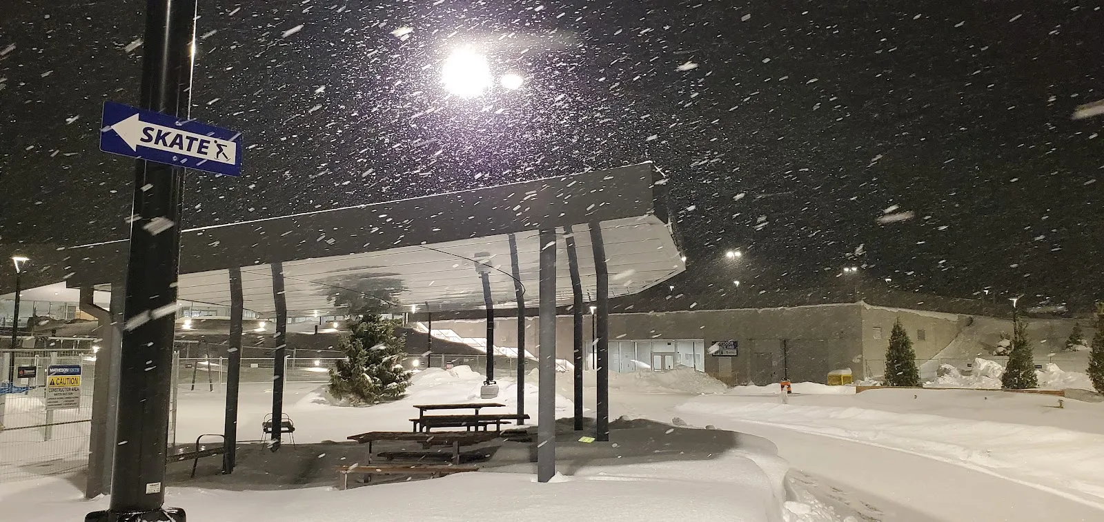 The Carrville skate trail shelter and snow-covered trail at night in a snowfall — Carrville Community Centre Skating Trail (Vaughan)
