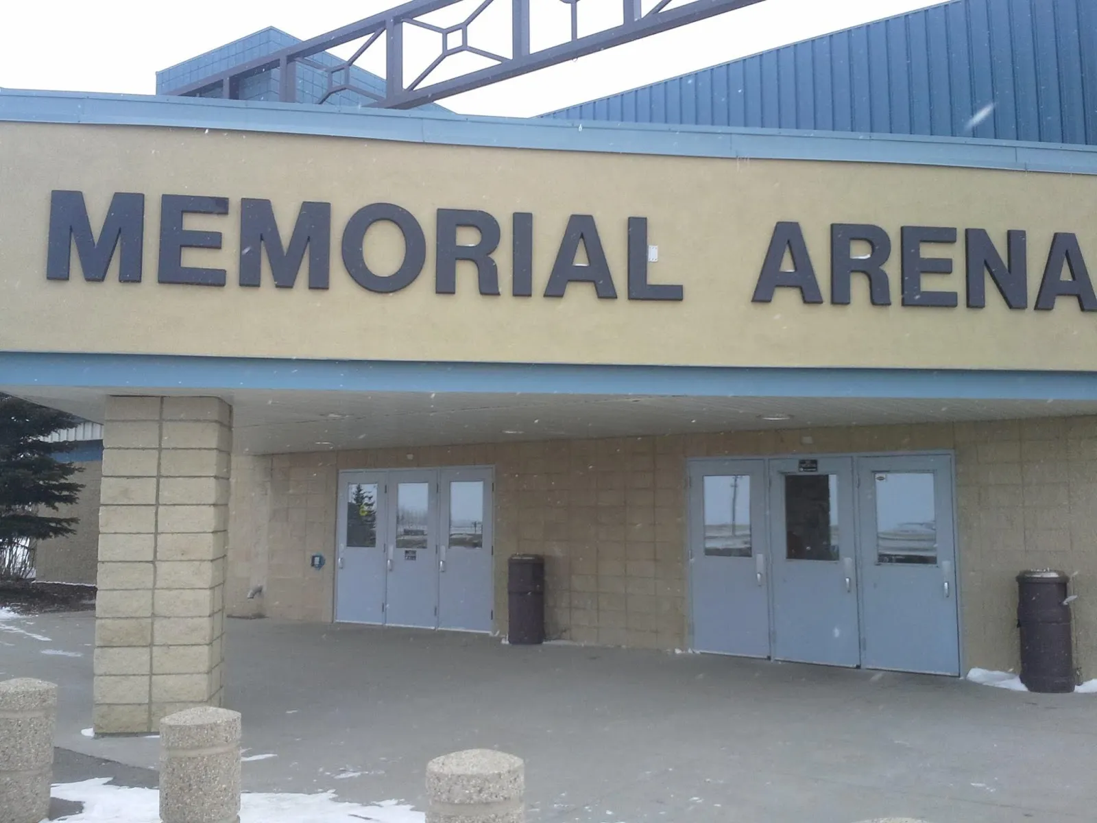 The Memorial Arena entrance in Carstairs: blue double doors under large lettering on a cream wall. — Carstairs Memorial Arena