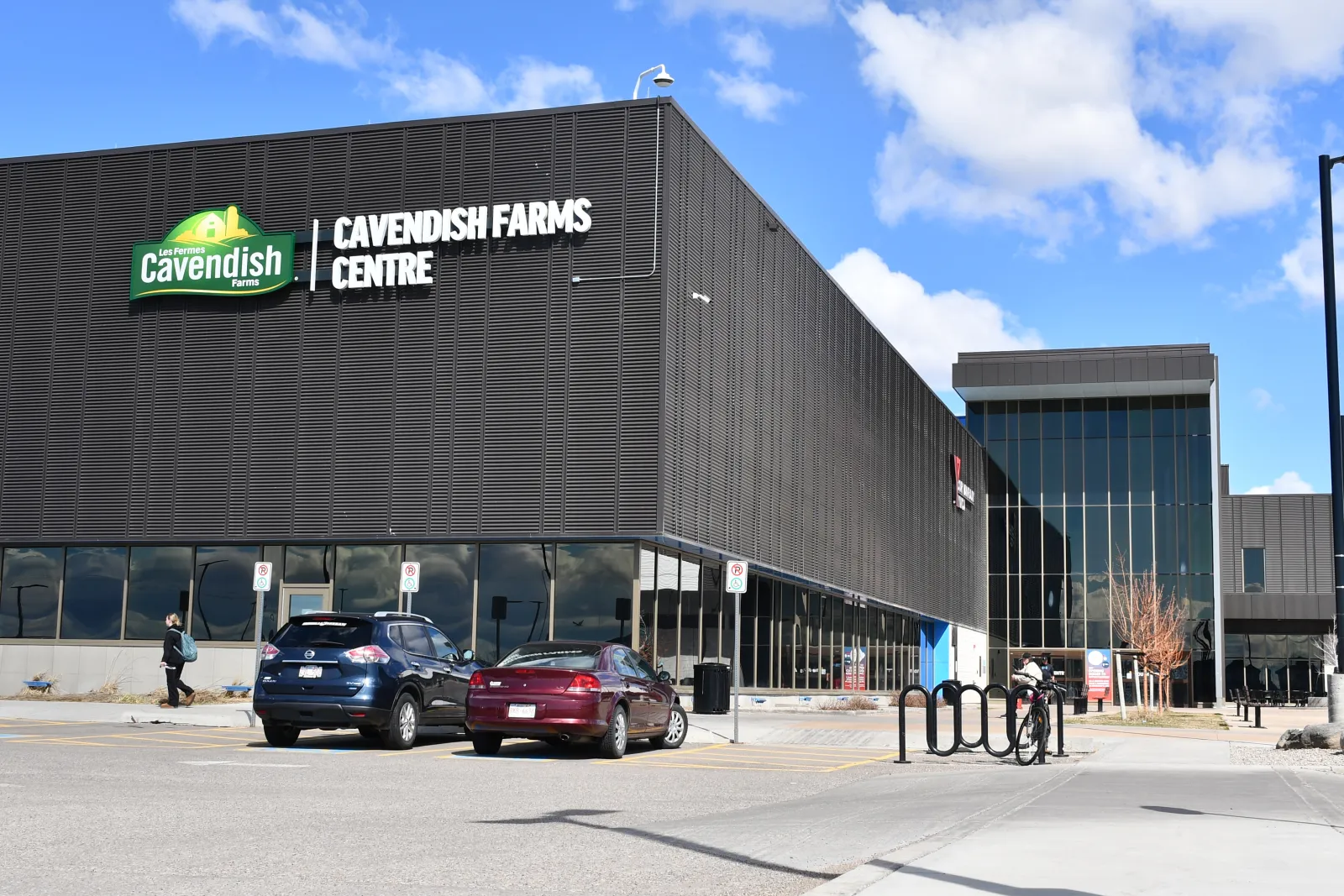 The dark-clad Cavendish Farms Centre on Mauretania Road West in Lethbridge, with its name sign and glass entrance block — Cavendish Farms Centre