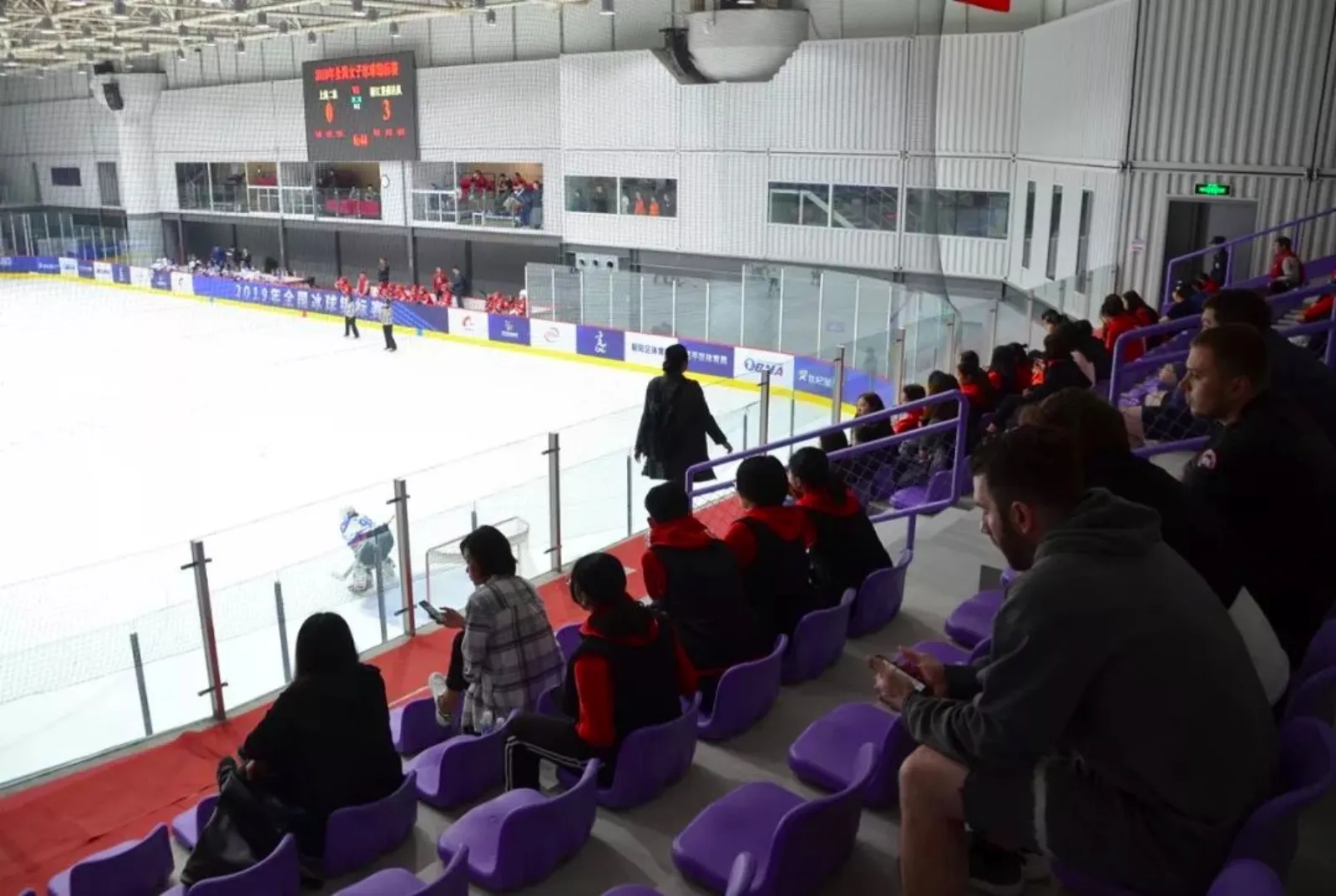 Hall A, the main hall, seen from the stands during a game, with the scoreboard over the ice and spectators in the stands — Century Star International Winter Sports Center