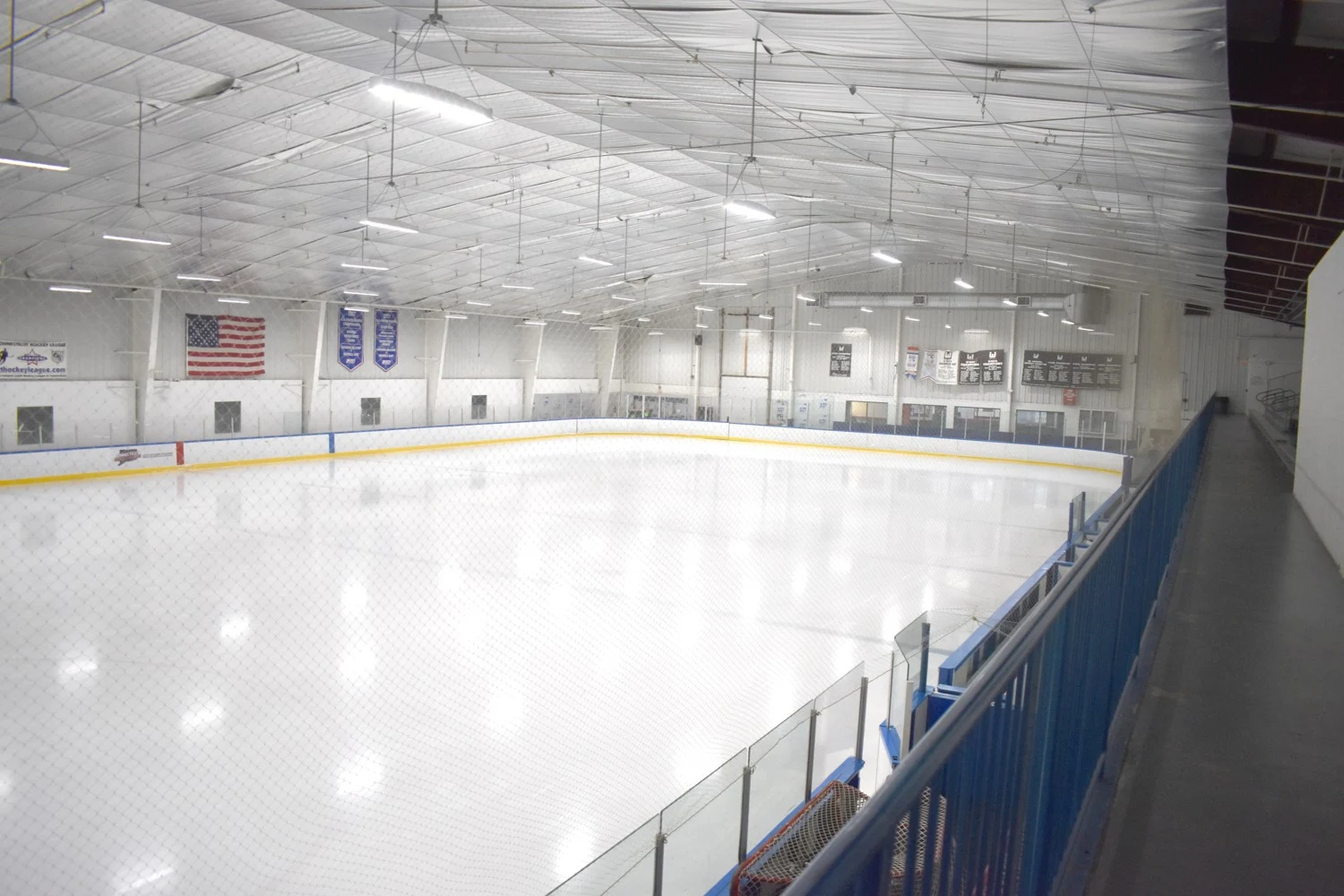 A wide view of the ice and spectator seating inside Champions Skating Center. — Champions Skating Center