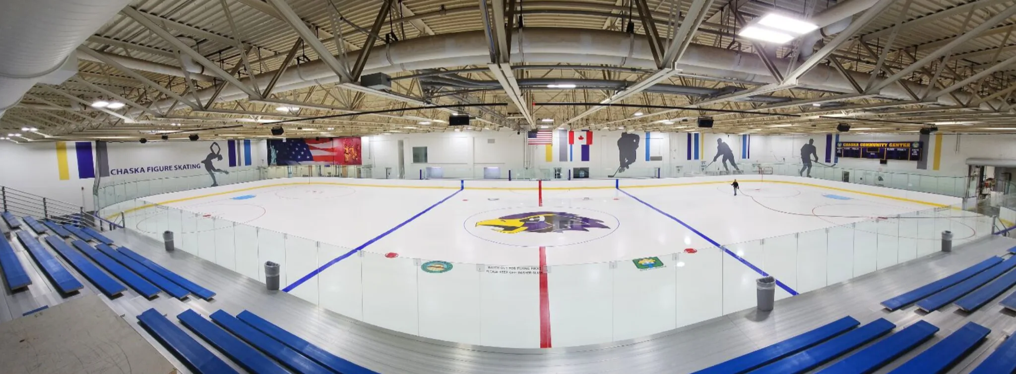 Full sheet of ice at the Chaska Community Center in a wide panorama from the bleachers — Chaska Community Center Ice Rink