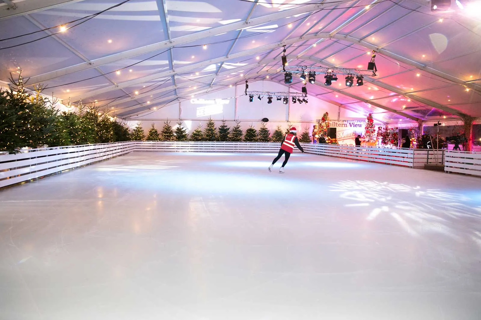 The covered ice rink with a skater under the tent roof (the operator's photo of an earlier season) — Chiltern View Ice Rink