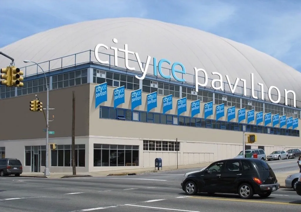 Building seen across a wide city intersection — City Ice Pavilion