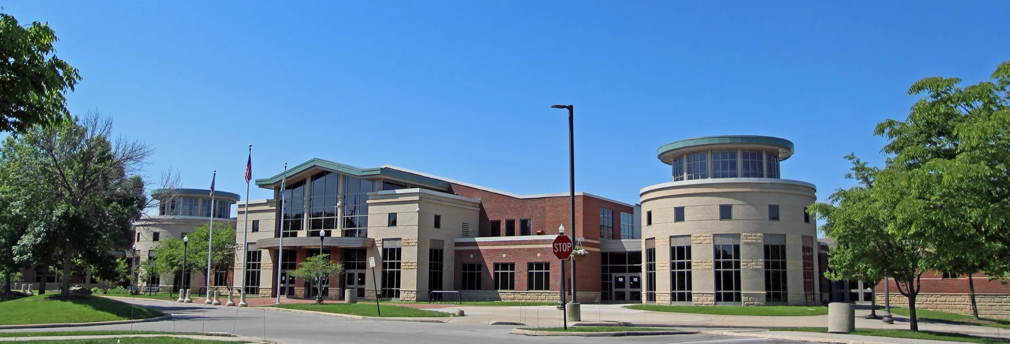 Brick-and-stone Cleveland Heights Community Center with its round corner towers on a sunny day — Cleveland Heights Community Center (North Rink)