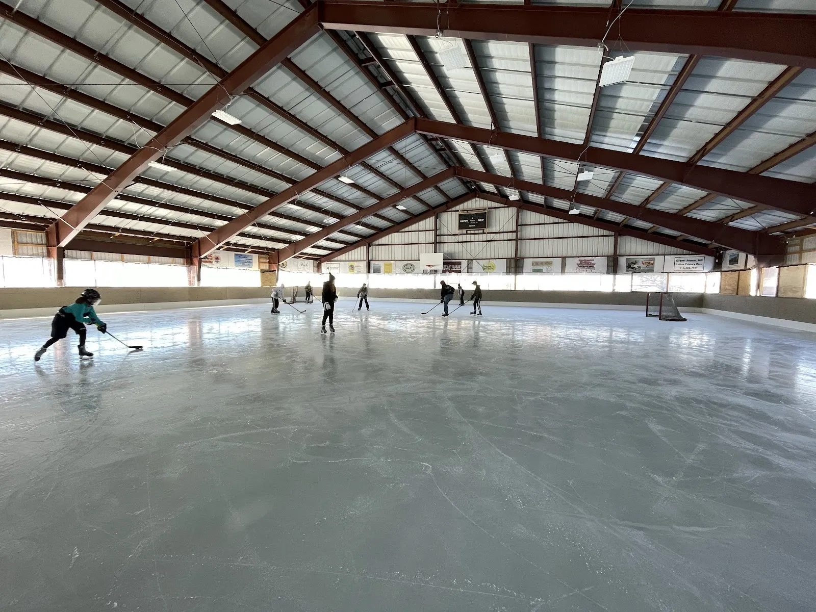 The covered Colton rink with a few skaters at a distance — Colton Ice Rink at Swift Field