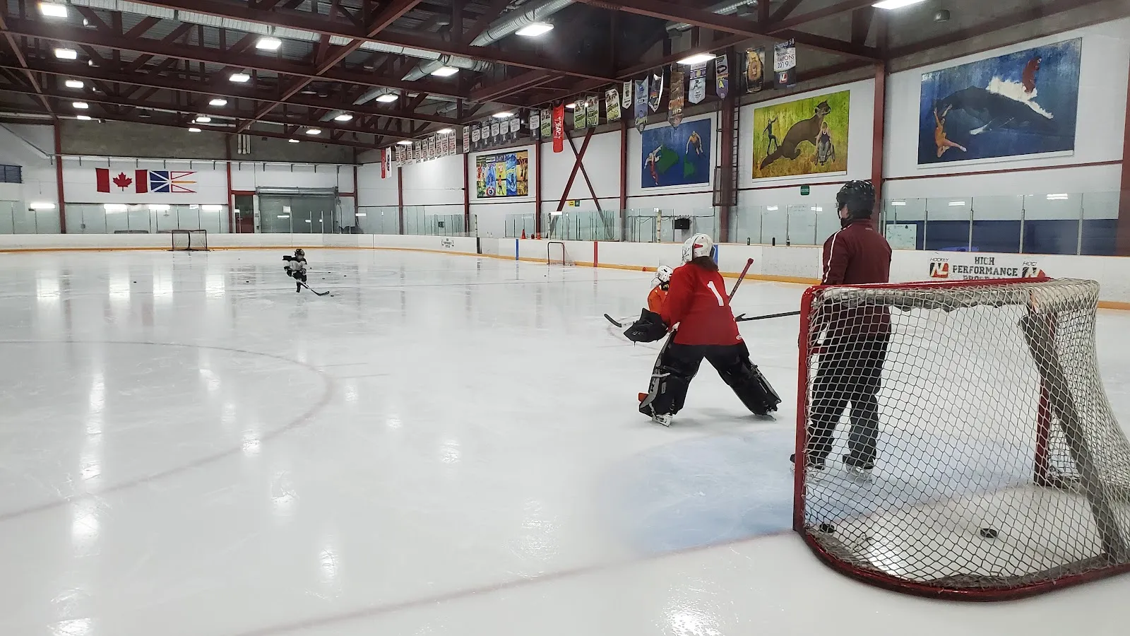 A goalie and skaters on the ice of the Main Arena at the Corner Brook Civic Centre — Corner Brook Civic Centre