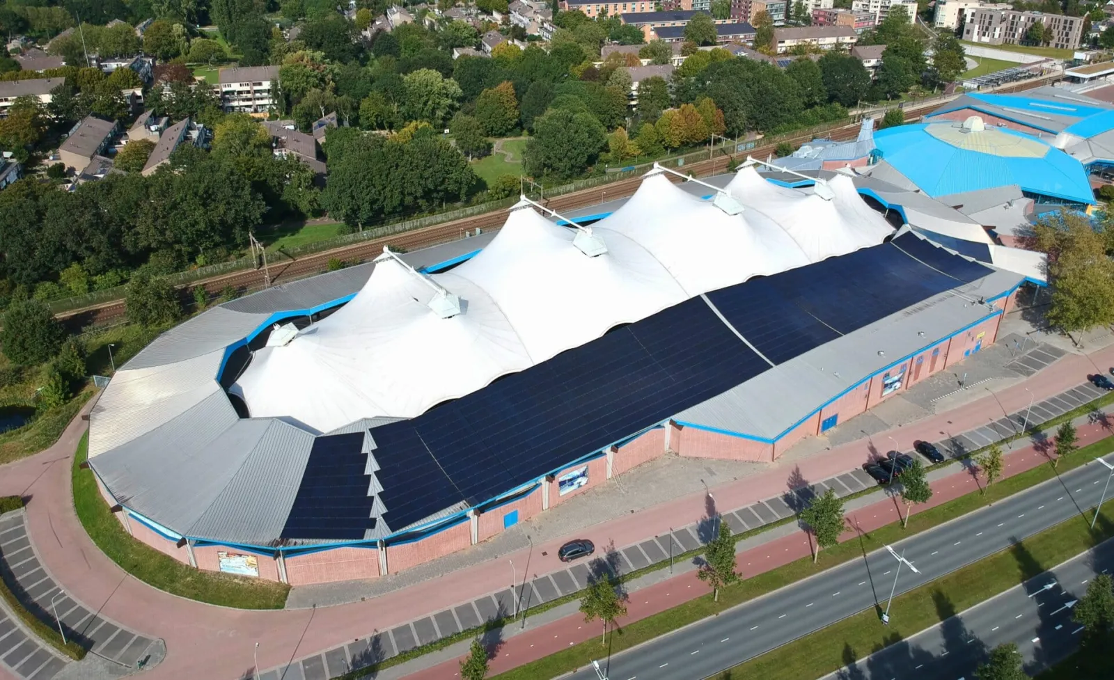 Aerial view of De Scheg, the sports centre with the ice rink under its white tent roof — De Scheg ijsbaan