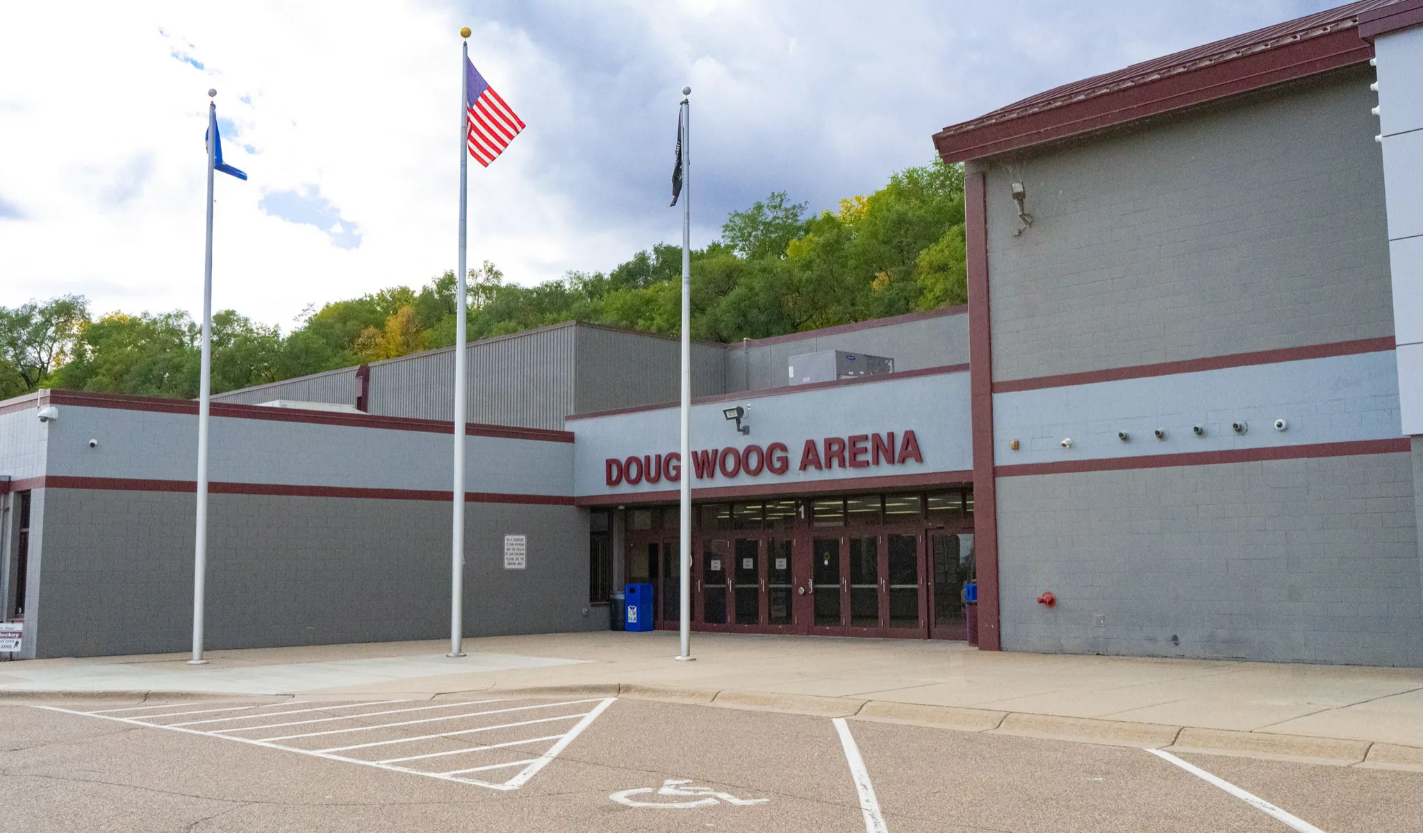 Front of Doug Woog Arena, a low grey block building with maroon trim — Doug Woog Arena