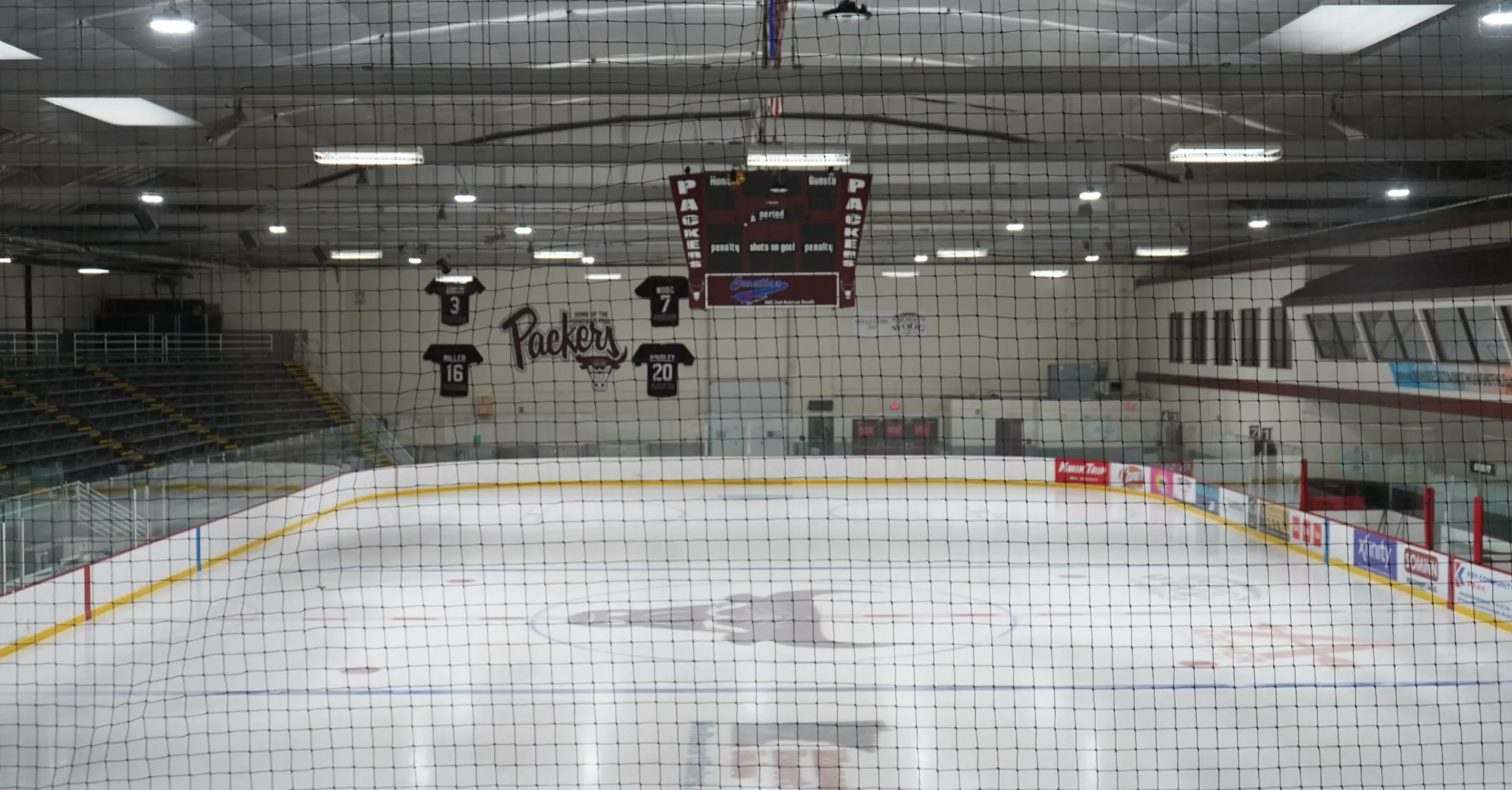 Main sheet at Doug Woog Arena seen end-on through the safety netting — Doug Woog Arena
