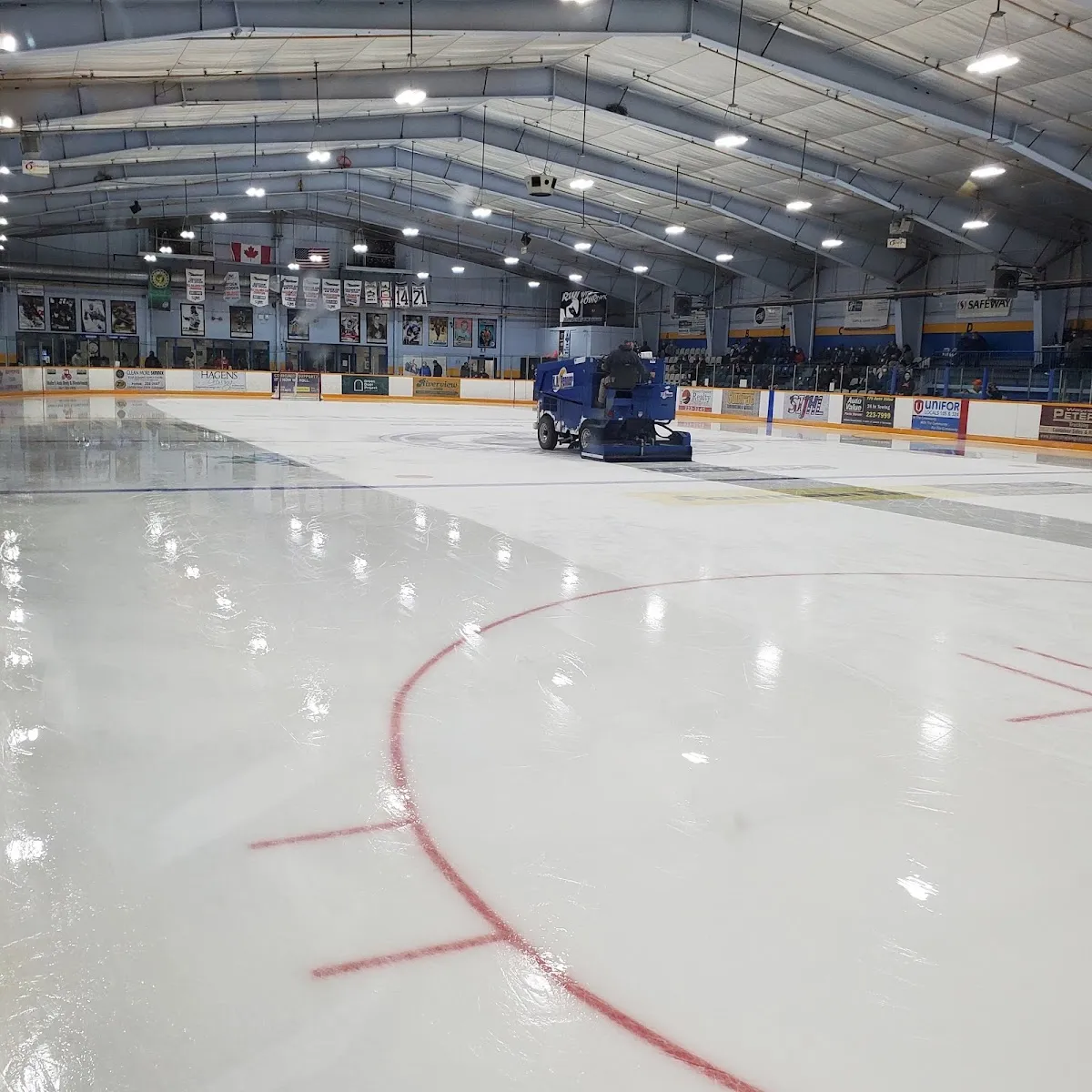 The fresh ice at Dryden Memorial Arena with the red line, boards and a resurfacer in the far corner. — Dryden Memorial Arena
