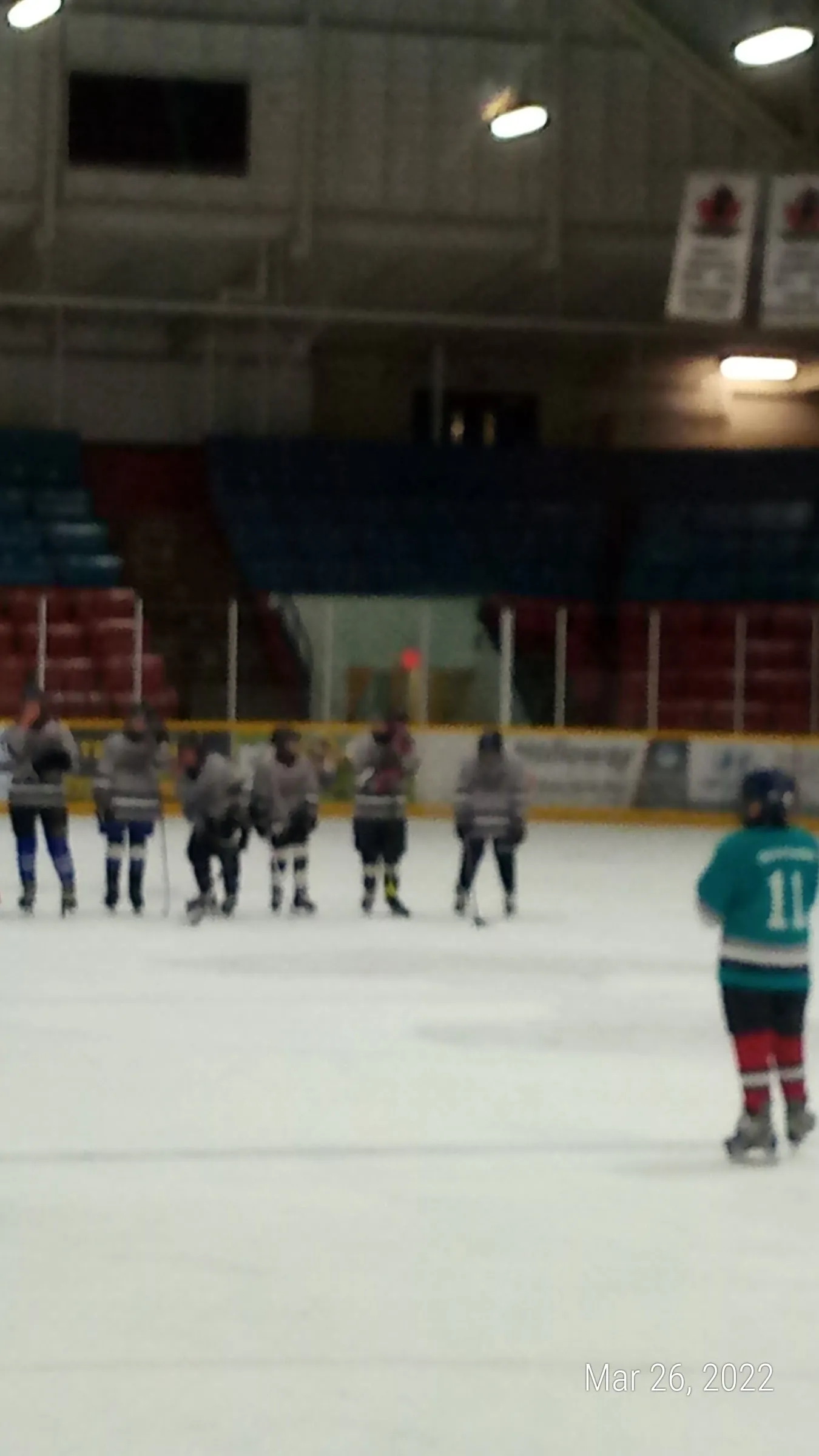 Players lined up on the ice at Dufferin Arena during a game (photo from the Google Maps listing) — Dufferin Arena
