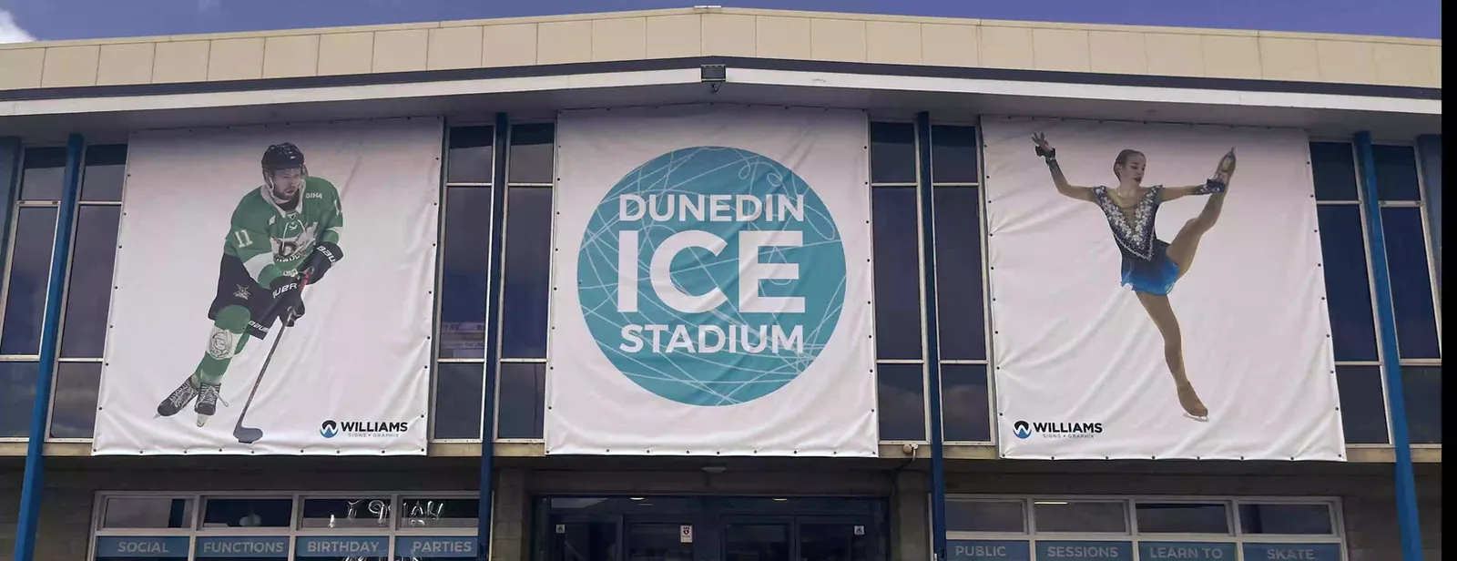 The front of Dunedin Ice Stadium with its entrance banners — Dunedin Ice Stadium