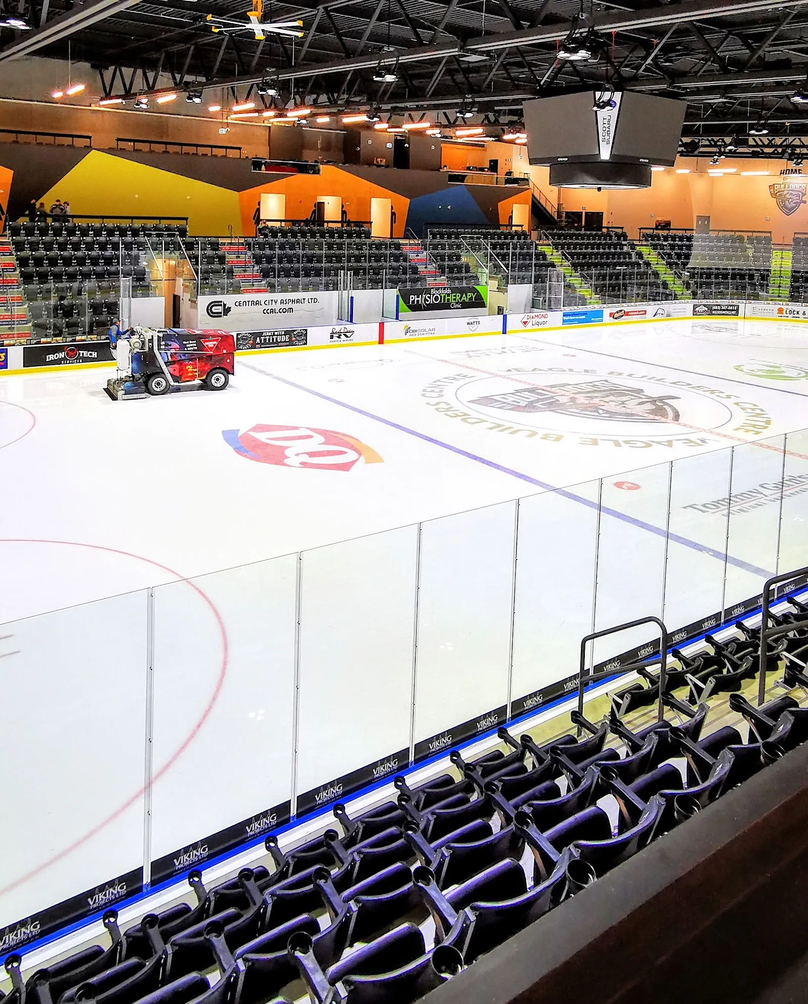 The Eagle Builders Centre main ice with the Zamboni at the far boards, the colourful seating bowl and the Bulldogs logo at centre ice. — Eagle Builders Centre
