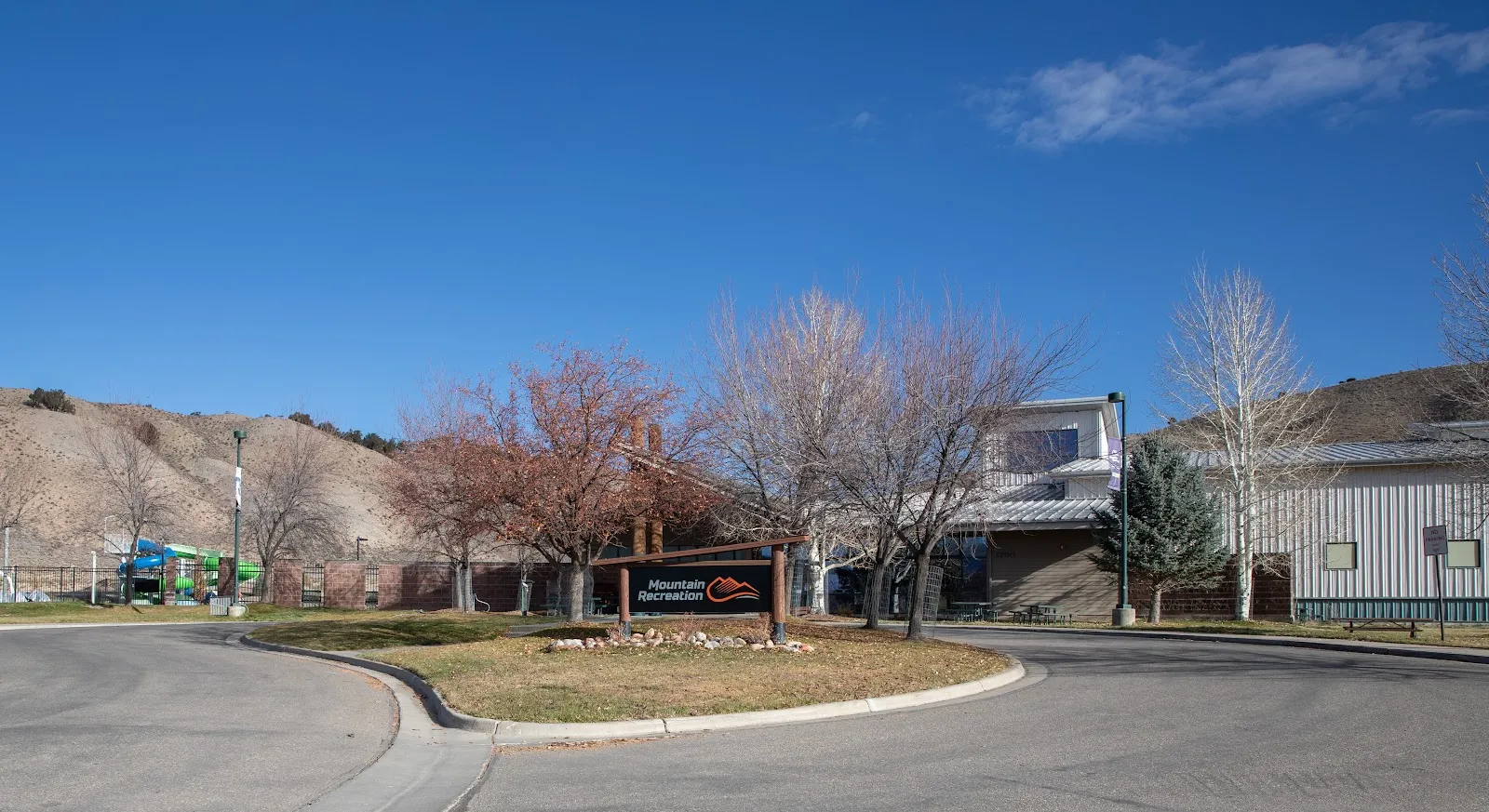 The entrance drive and Mountain Recreation sign in front of the Eagle Pool and Ice Rink building. — Eagle Pool & Ice Rink