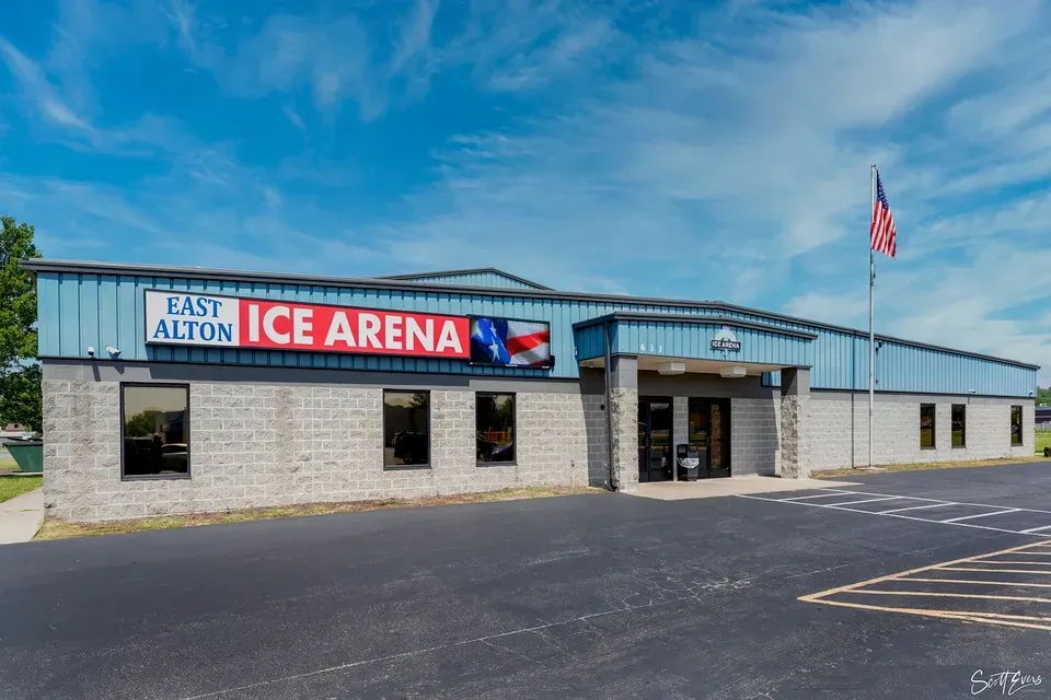 The red arena sign above an empty car park — East Alton Ice Arena