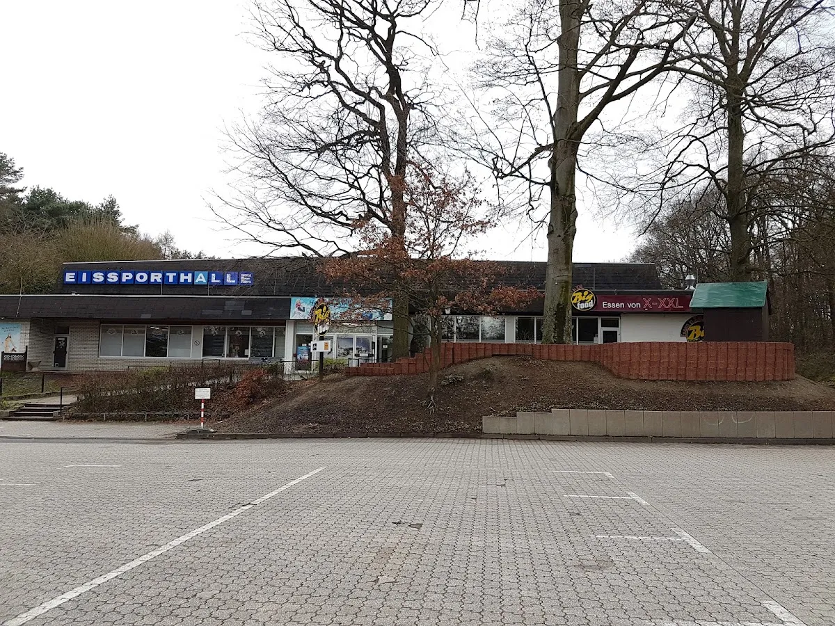 The Eissporthalle Bergisch Gladbach behind its car park, with the blue lettering above the entrance. — Eissportarena Bergisch Gladbach