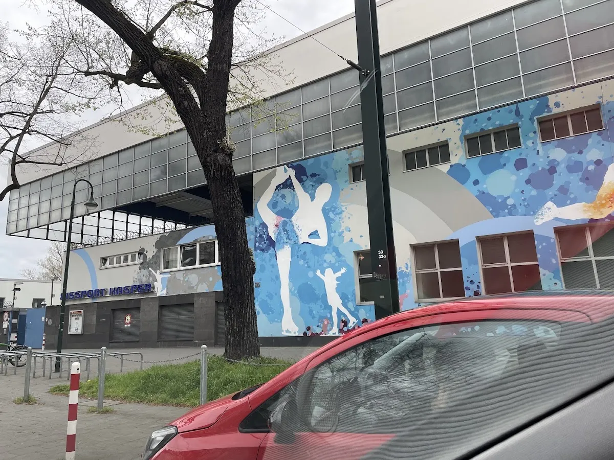 The Eisstadion an der Brehmstraße with its blue mural, seen from the street. — Eisstadion Brehmstraße