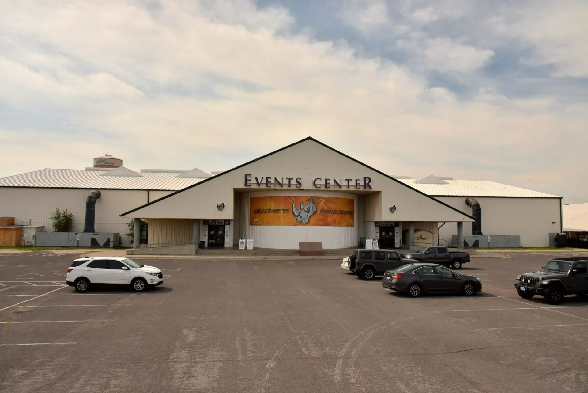 Events Center seen head-on from its parking lot under a hazy El Paso sky — El Paso County Events Center