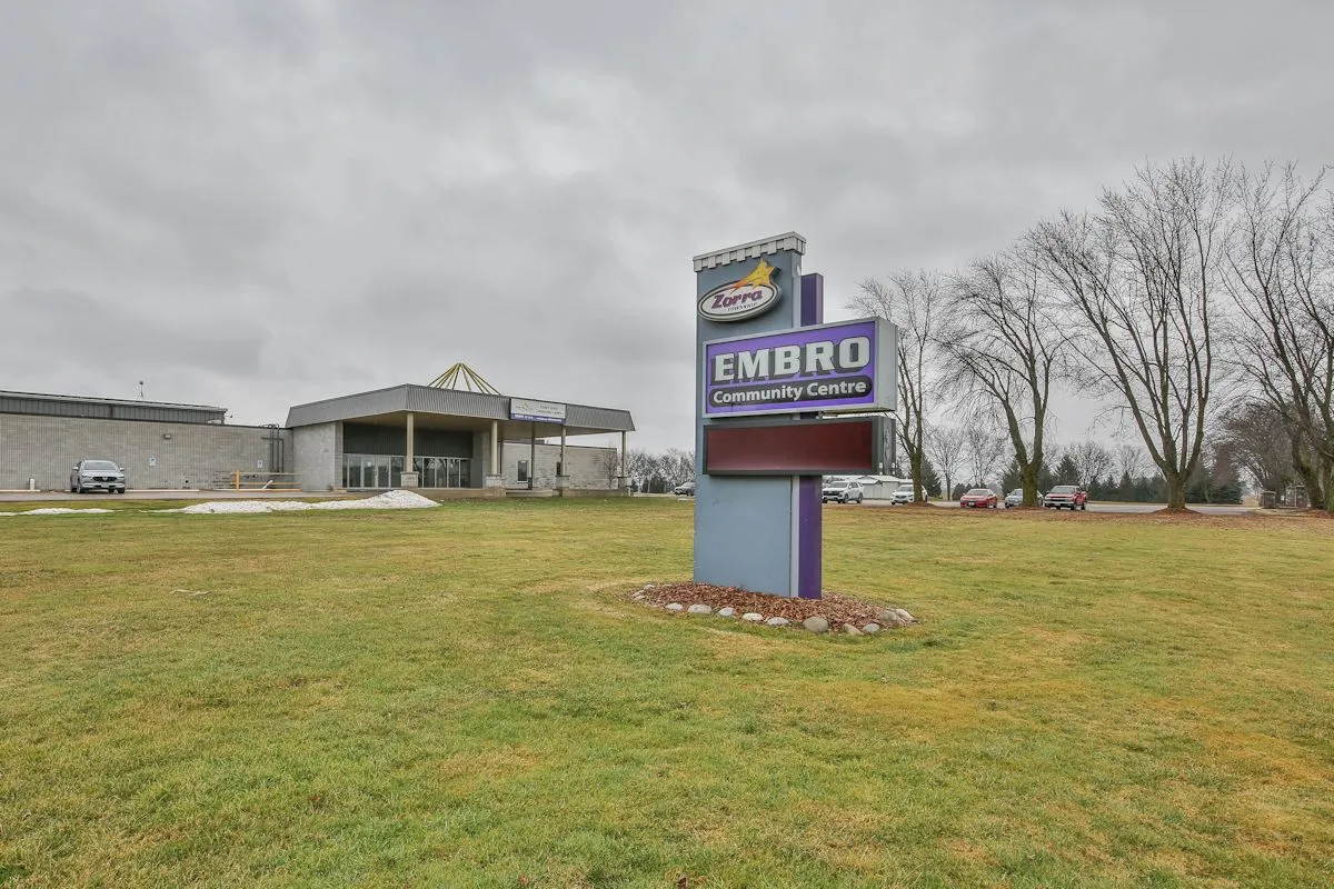 The low front of the Embro Community Centre behind its purple Embro Community Centre roadside sign. — Embro-Zorra Community Centre