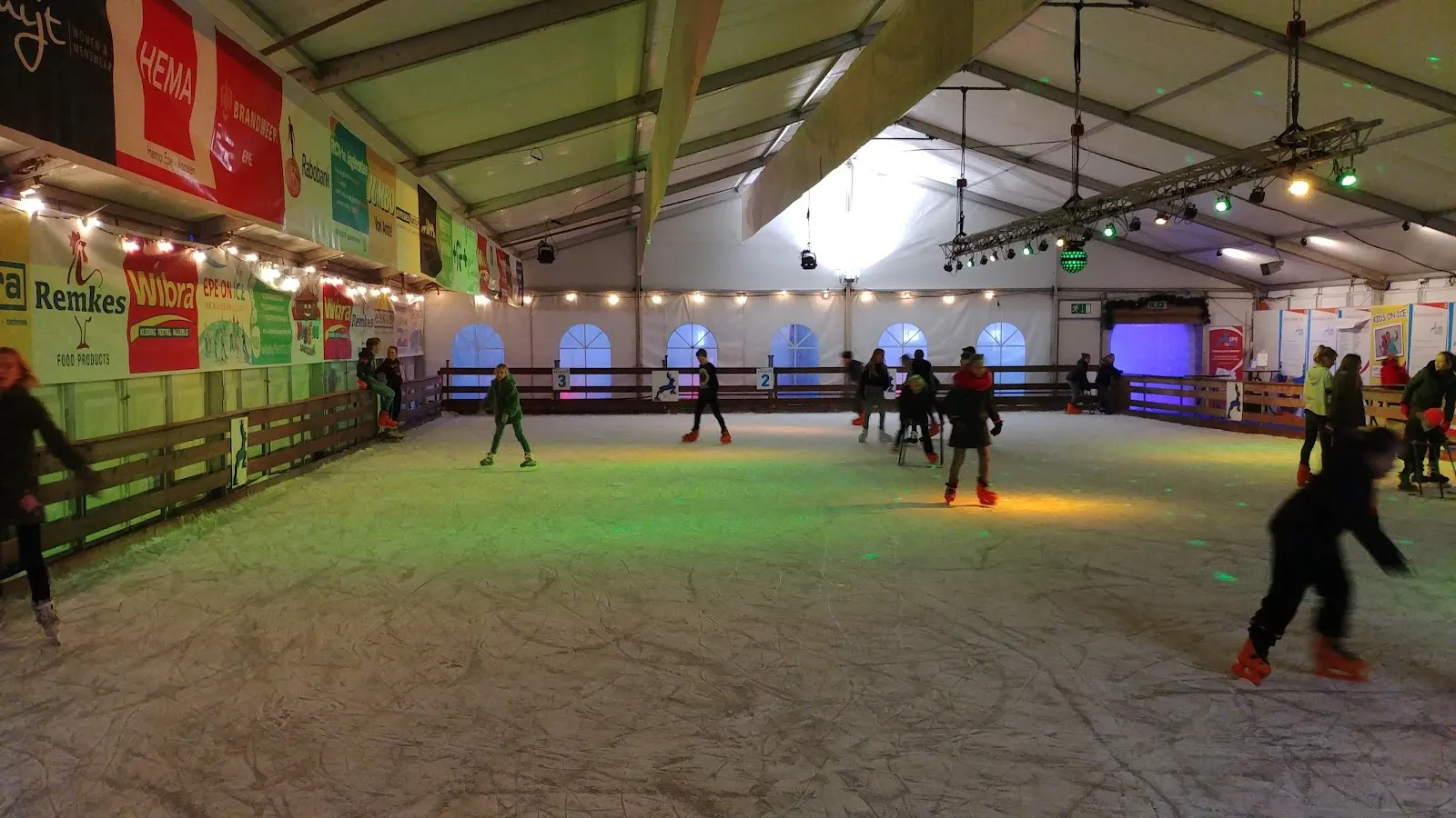 Schaatsers op het overdekte ijs van Epe on Ice in de tent in het Loeffpark – Epe on Ice