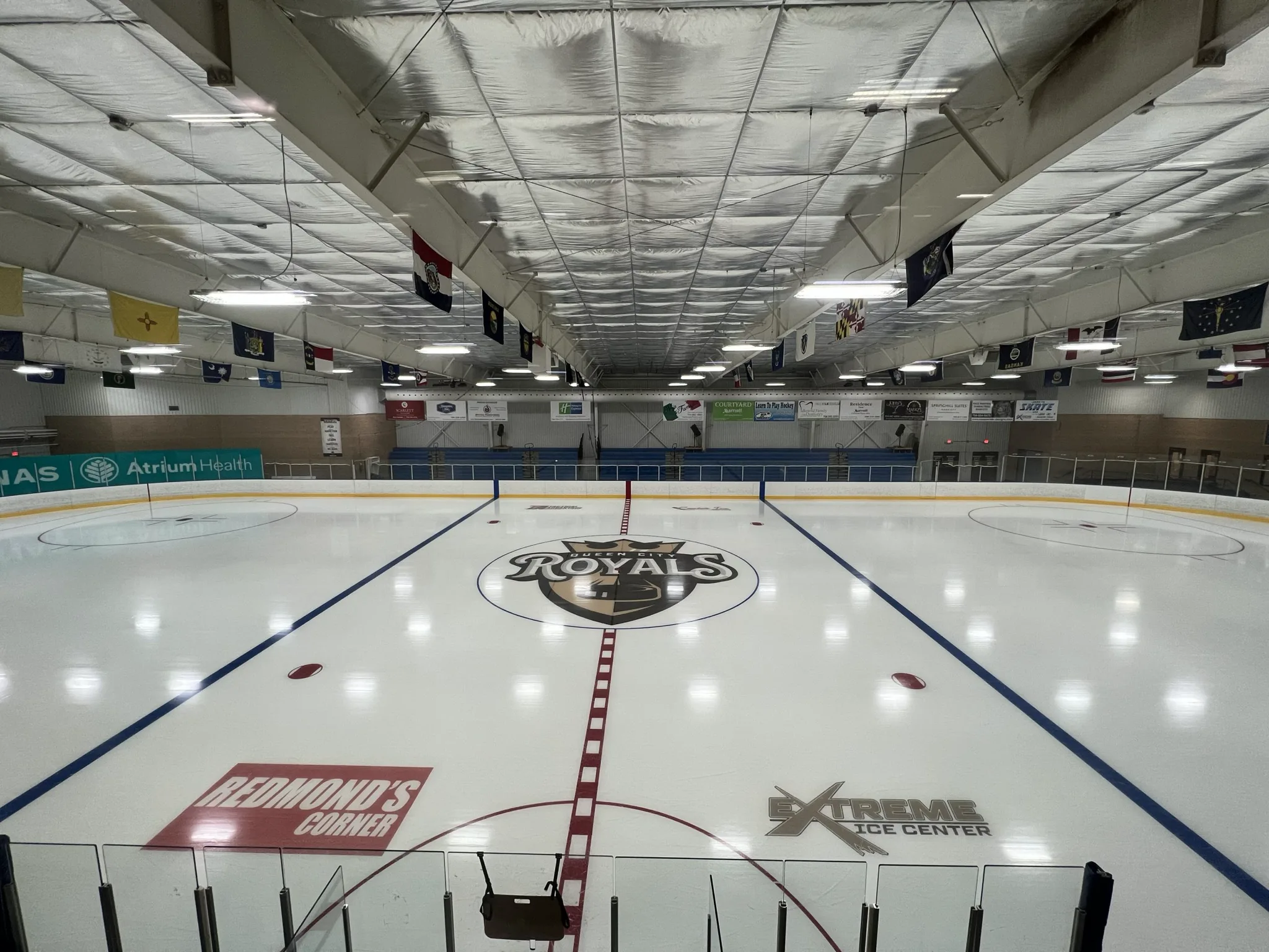 Freshly resurfaced ice sheet seen from behind the goal line — Extreme Ice Center