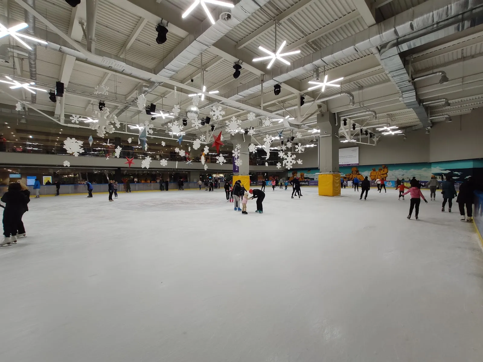 The ice sheet of the Fifty Ice Arena inside the mall, with snowflake decorations hanging from the ceiling — Fifty Ice Arena (Kyiv)