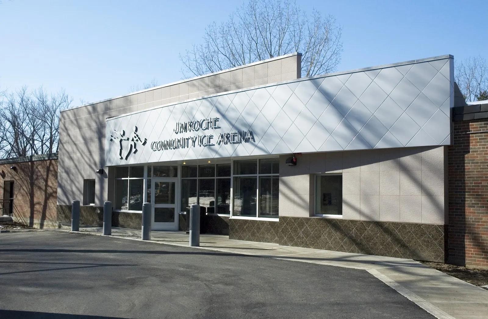 The Jim Roche Community Ice Arena entrance on VFW Parkway: the lettered panel facade over the glass doors, with the 1275 street number on the glass — Jim Roche Community Arena