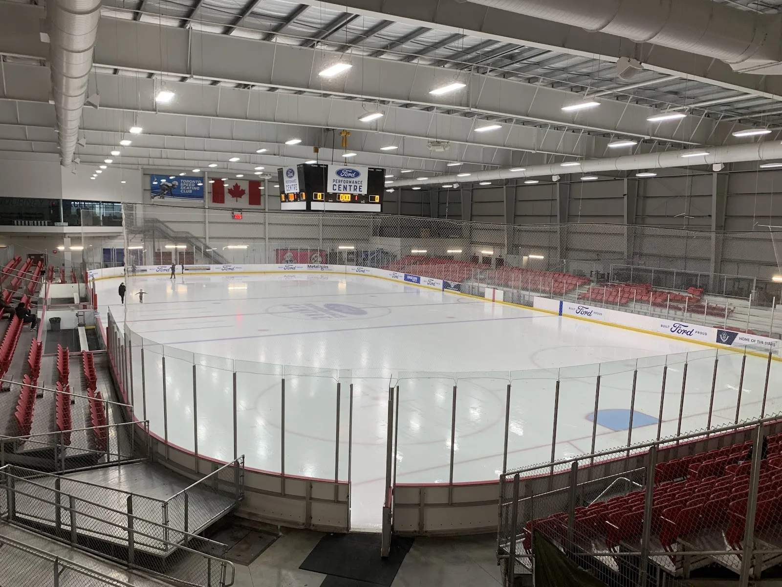 The main rink from the red seats, with the Ford Performance Centre scoreboard hanging over centre ice. — Ford Performance Centre