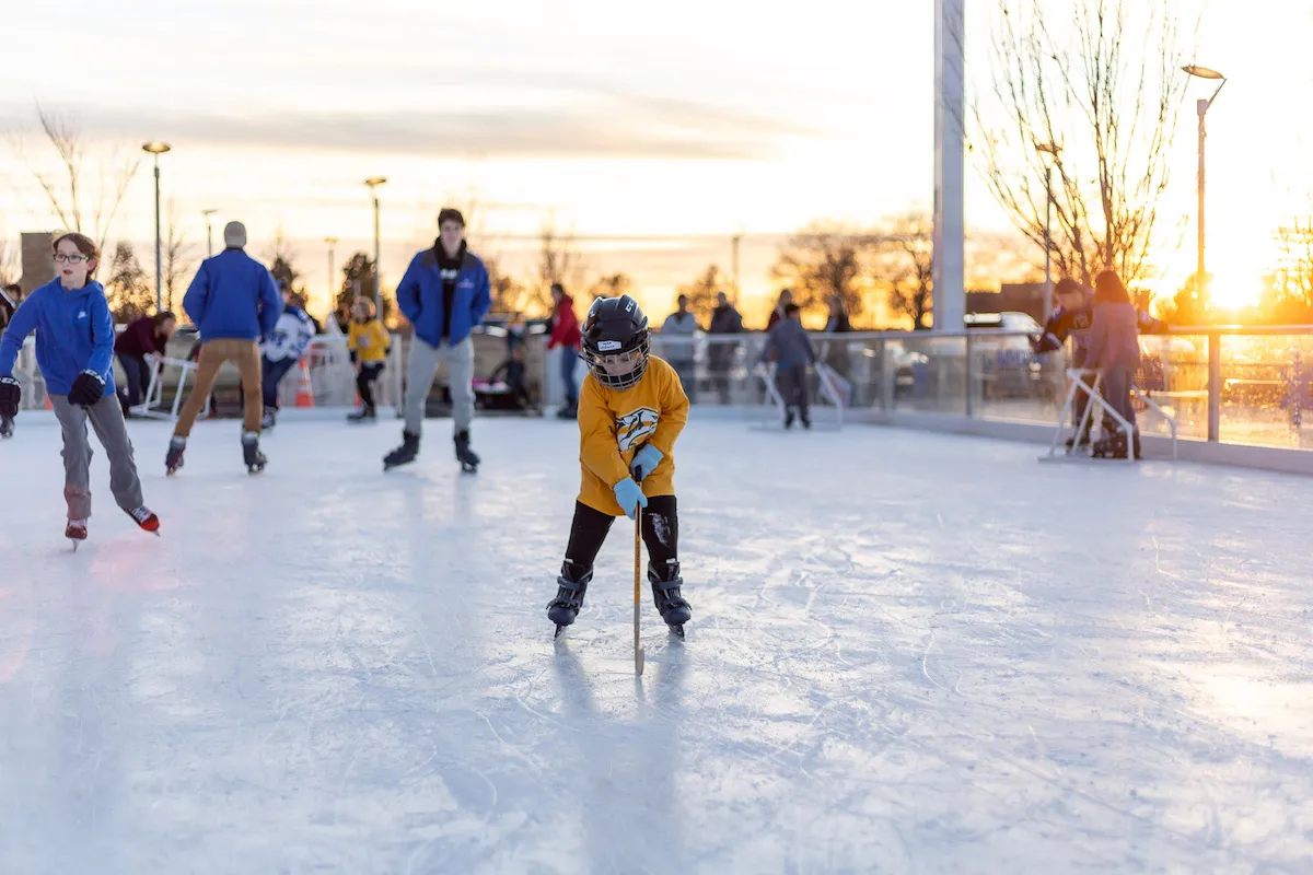 Skaters on the Fountains Winterfest ice at sunset — Fountains Winterfest Ice Rink