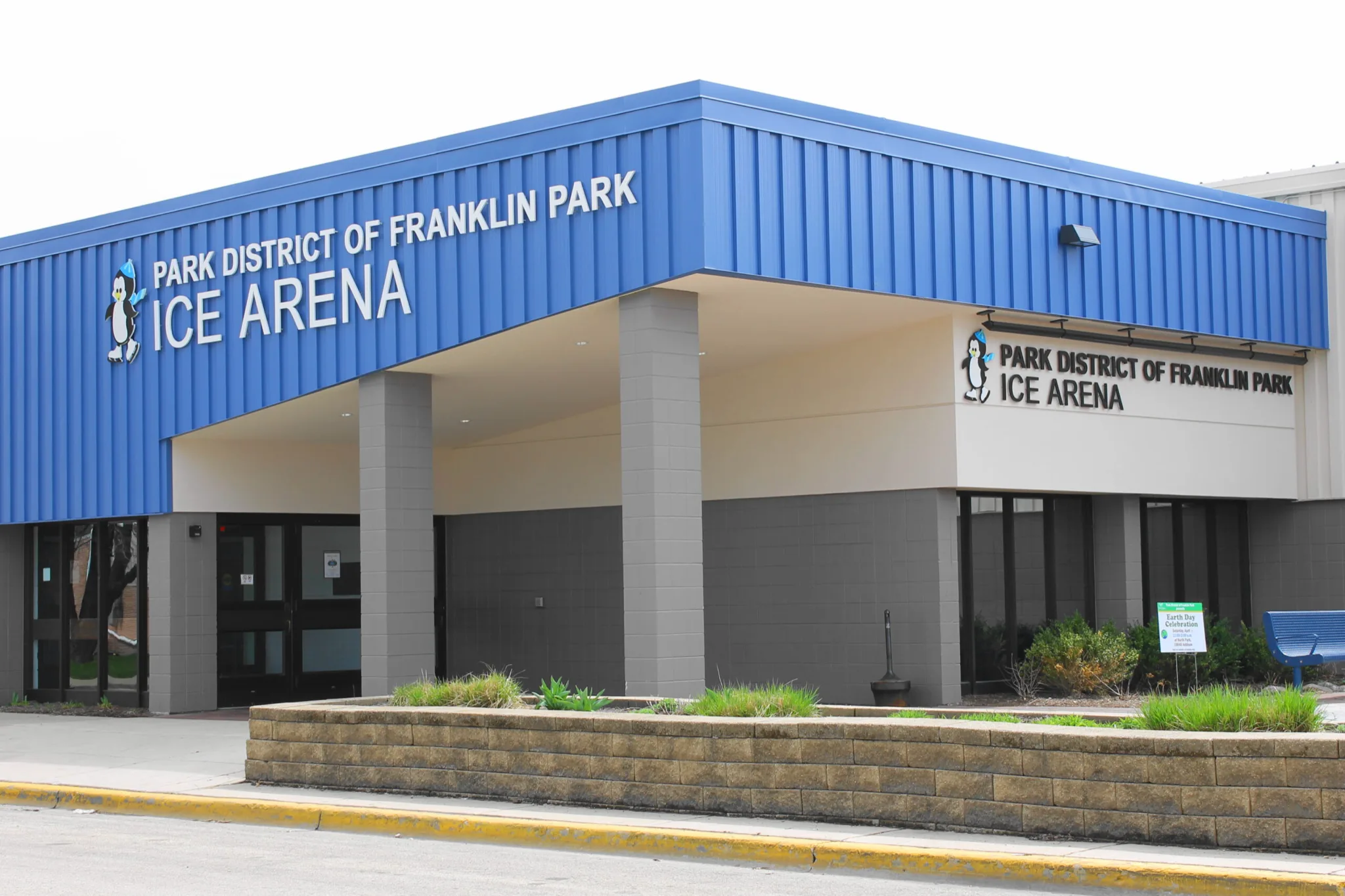 Bright blue panel wall above the glazed vestibule — Franklin Park Ice Arena
